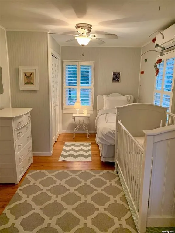 Bedroom featuring light wood-style flooring, a closet, a ceiling fan, and baseboards Bedroom featuring light wood-style flooring, a closet, a ceiling fan, and baseboards