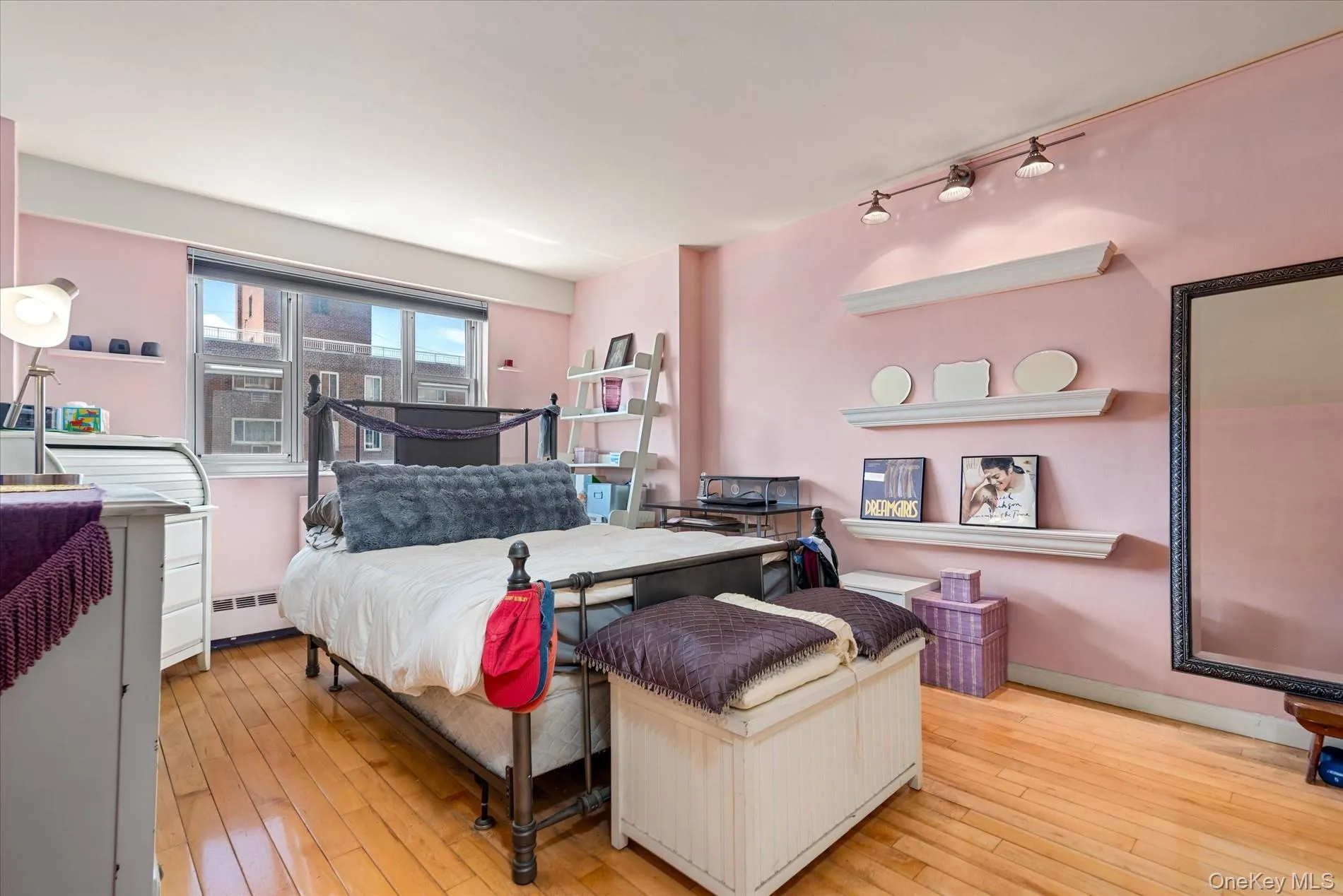 Bedroom with hardwood / wood-style floors and rail lighting Bedroom with hardwood / wood-style floors and rail lighting