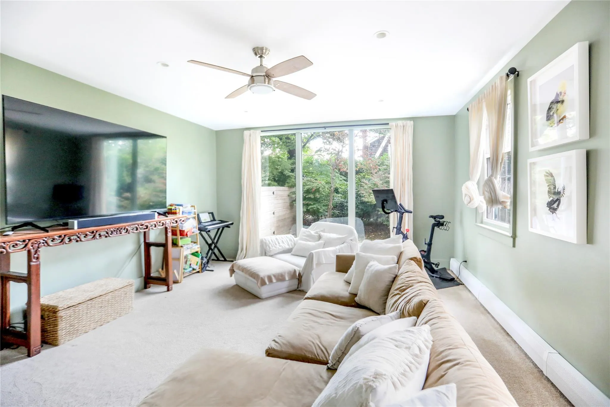 Carpeted living room featuring ceiling fan Carpeted living room featuring ceiling fan