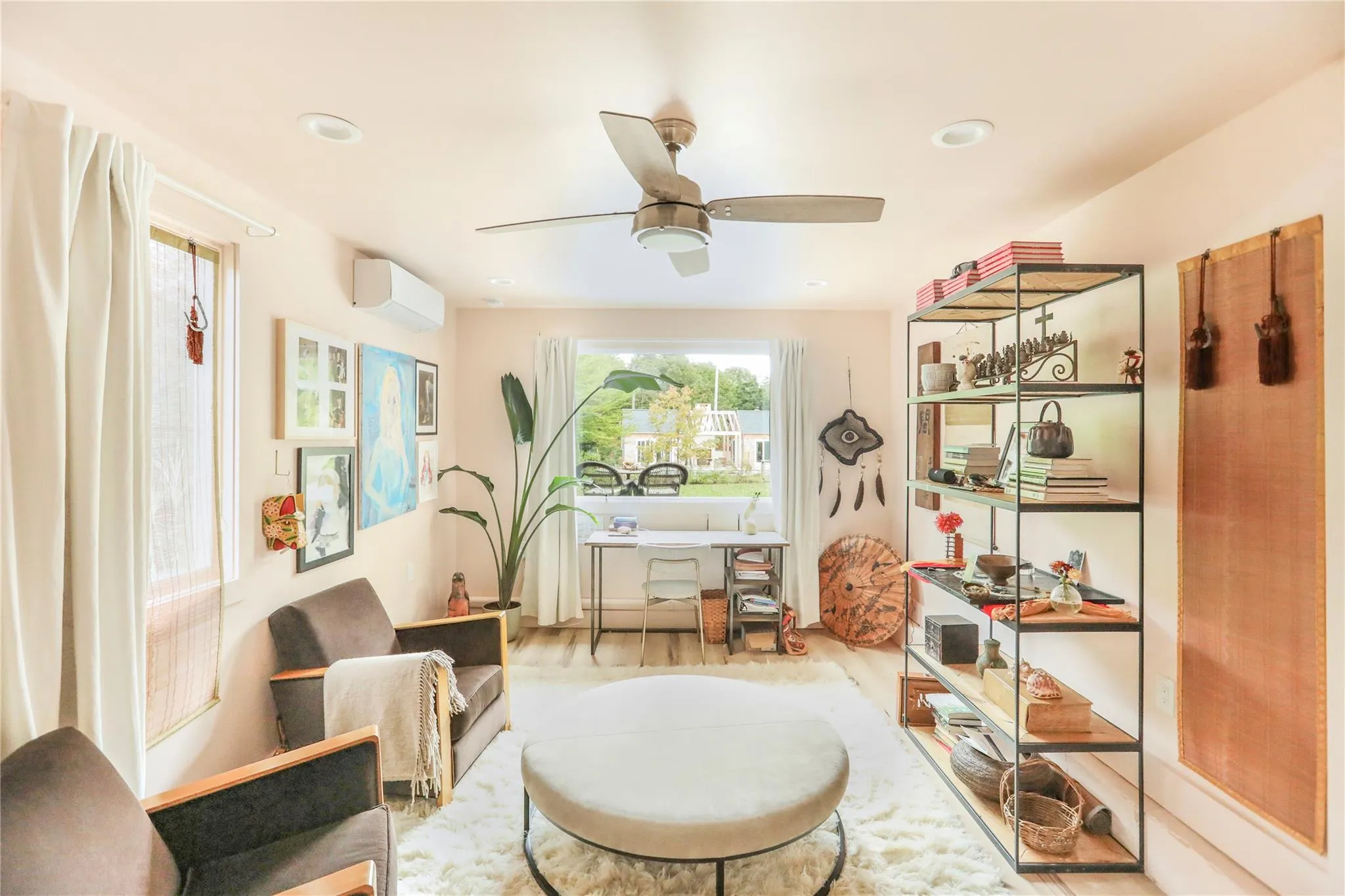 Sitting room with wood finished floors, healthy amount of natural light, a wall mounted AC, ceiling fan, and recessed lighting Sitting room with wood finished floors, healthy amount of natural light, a wall mounted AC, ceiling fan, and recessed lighting