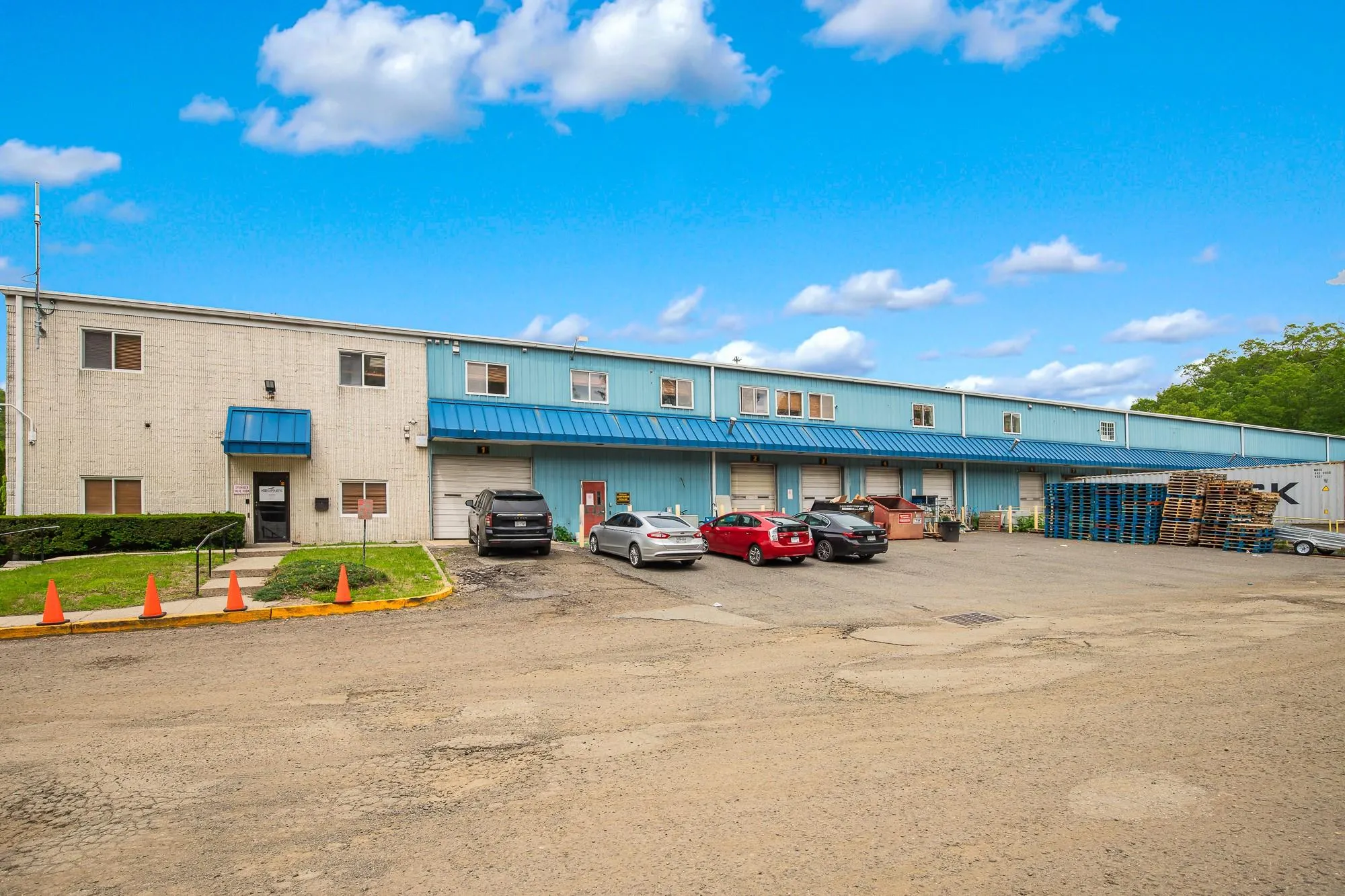 View of building exterior featuring uncovered parking View of building exterior featuring uncovered parking