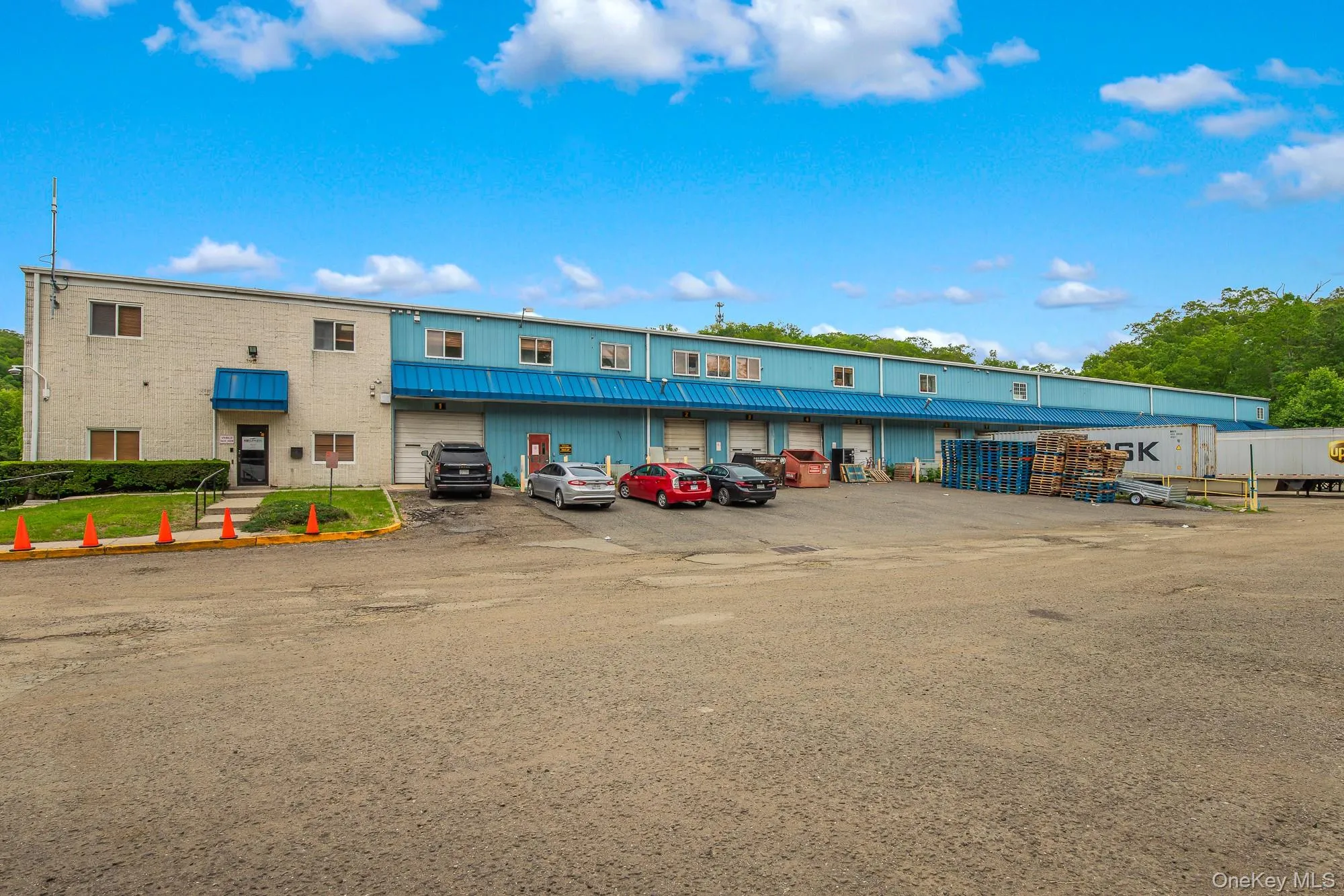 View of building exterior with uncovered parking View of building exterior with uncovered parking