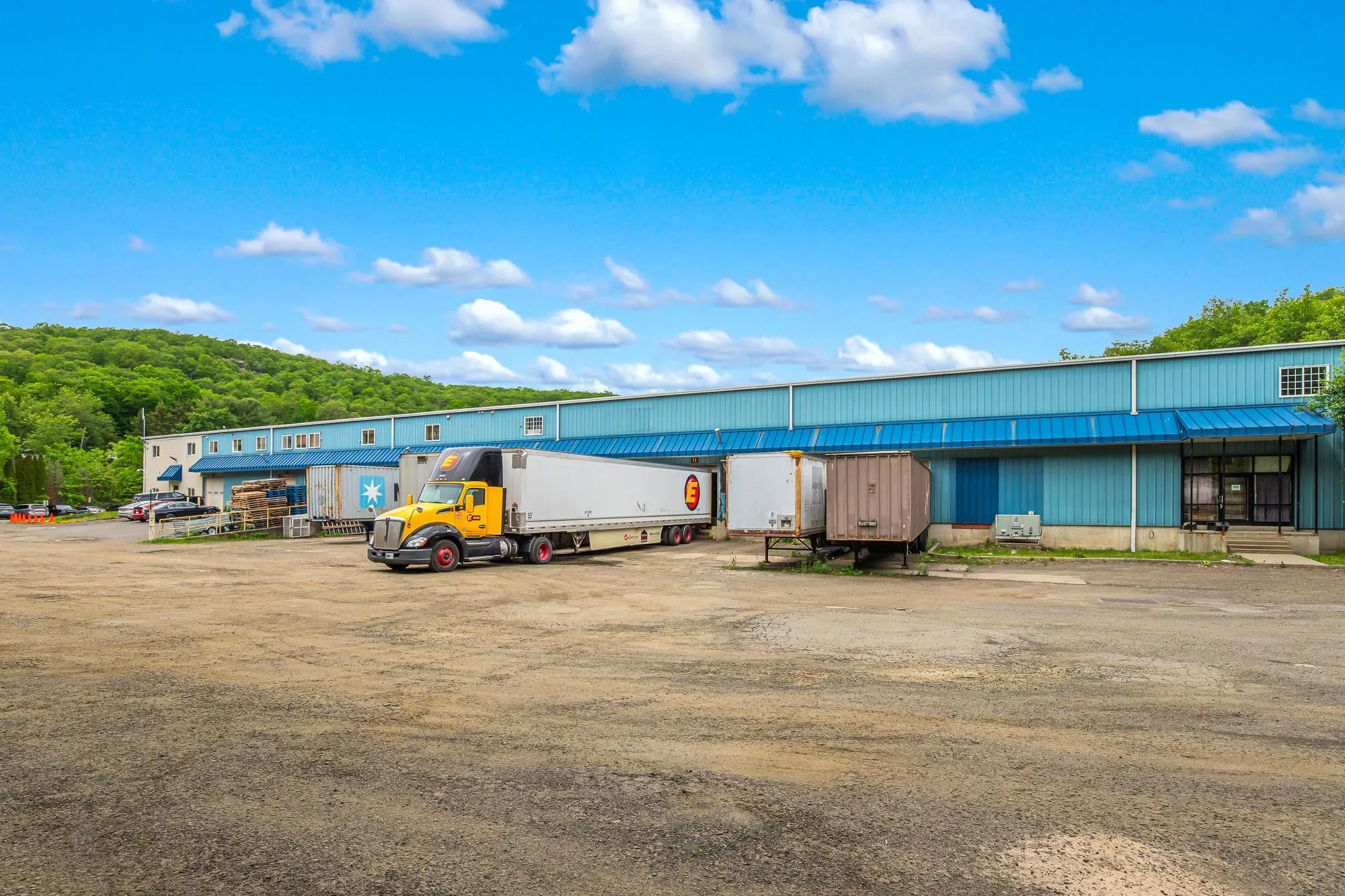 View of building exterior featuring uncovered parking View of building exterior featuring uncovered parking