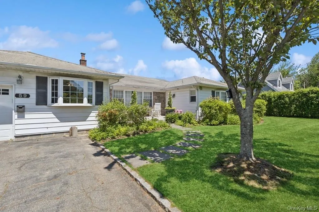 Ranch-style home featuring a front yard and a chimney Ranch-style home featuring a front yard and a chimney
