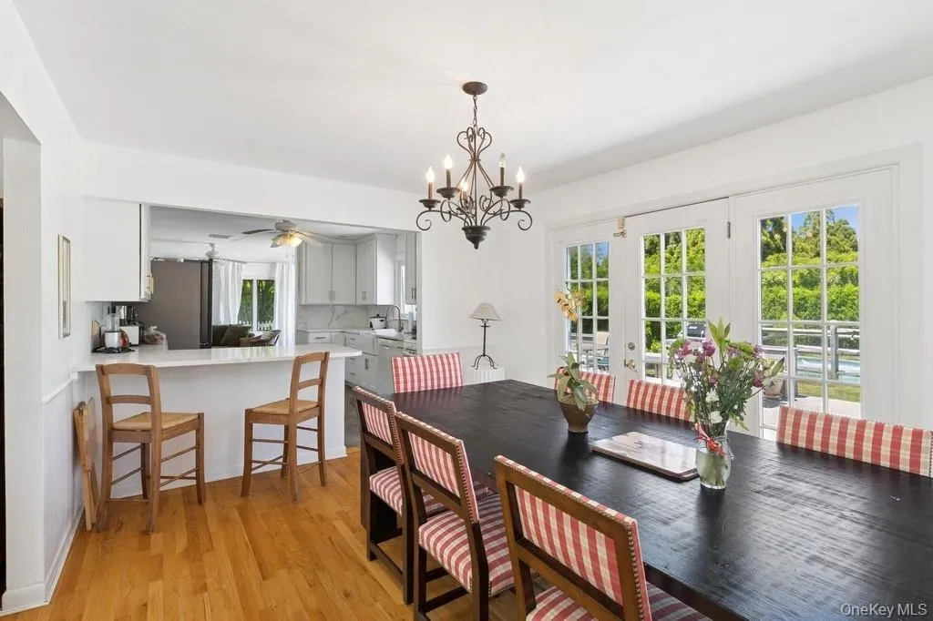 Dining space with plenty of natural light, ceiling fan, light wood-style floors, and french doors Dining space with plenty of natural light, ceiling fan, light wood-style floors, and french doors