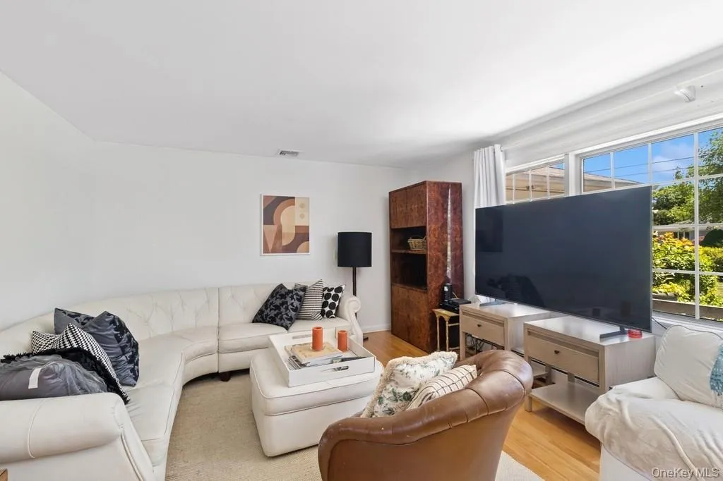 Living room with wood finished floors and plenty of natural light Living room with wood finished floors and plenty of natural light