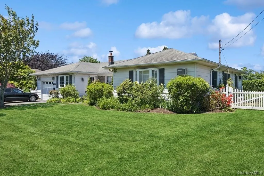 View of front of home featuring a garage and a chimney View of front of home featuring a garage and a chimney