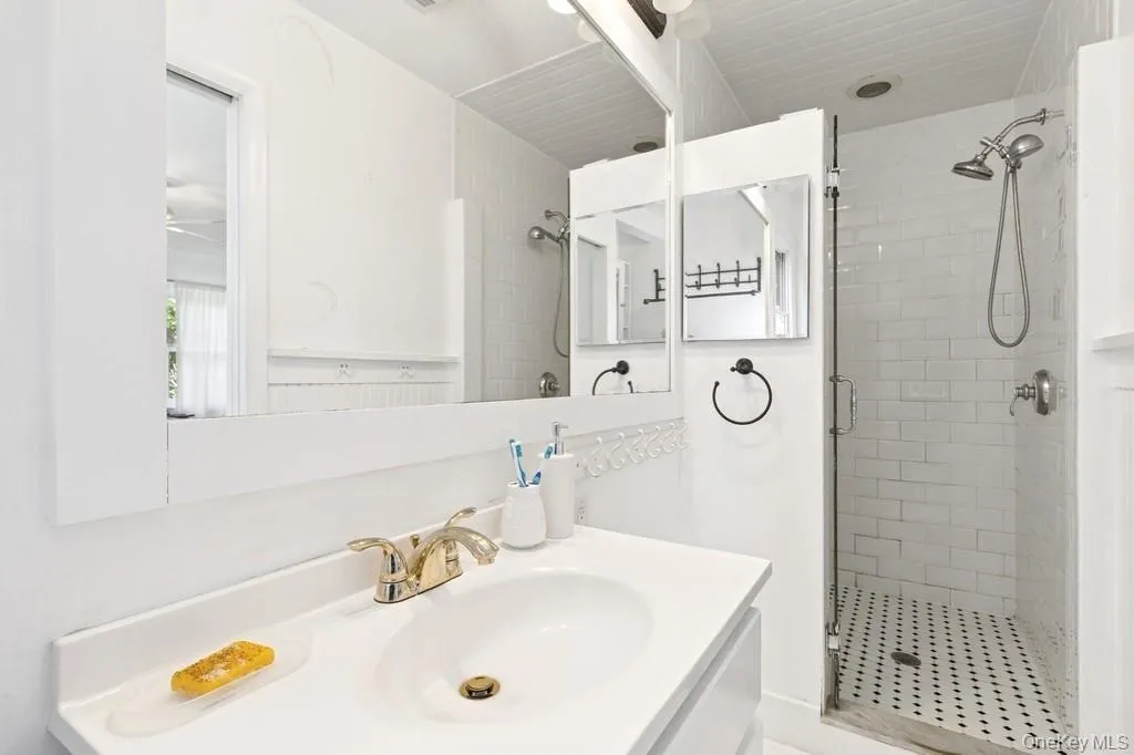 Bathroom with a shower stall and vanity Bathroom with a shower stall and vanity