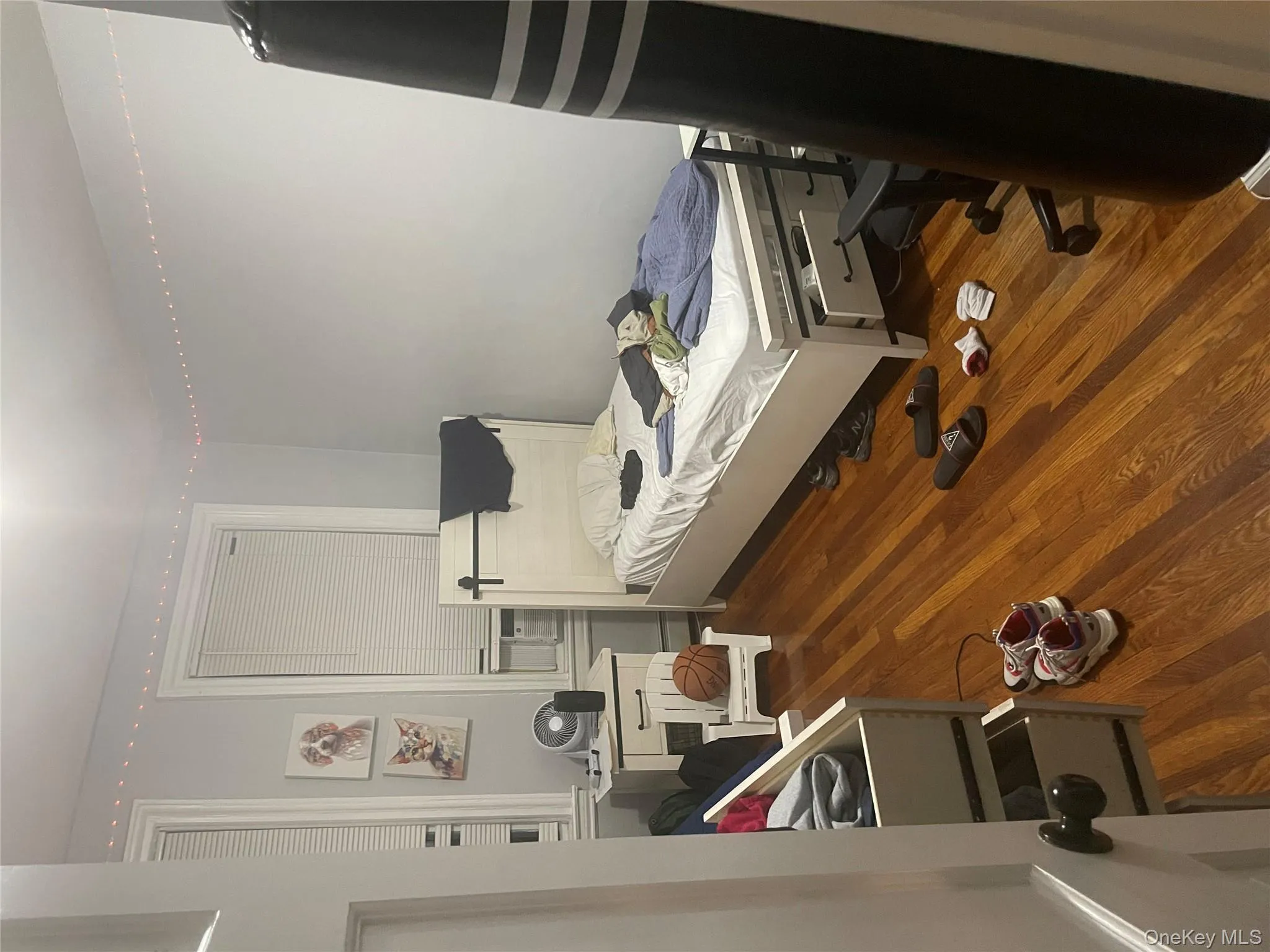 Bedroom featuring wood finished floors and cooling unit Bedroom featuring wood finished floors and cooling unit