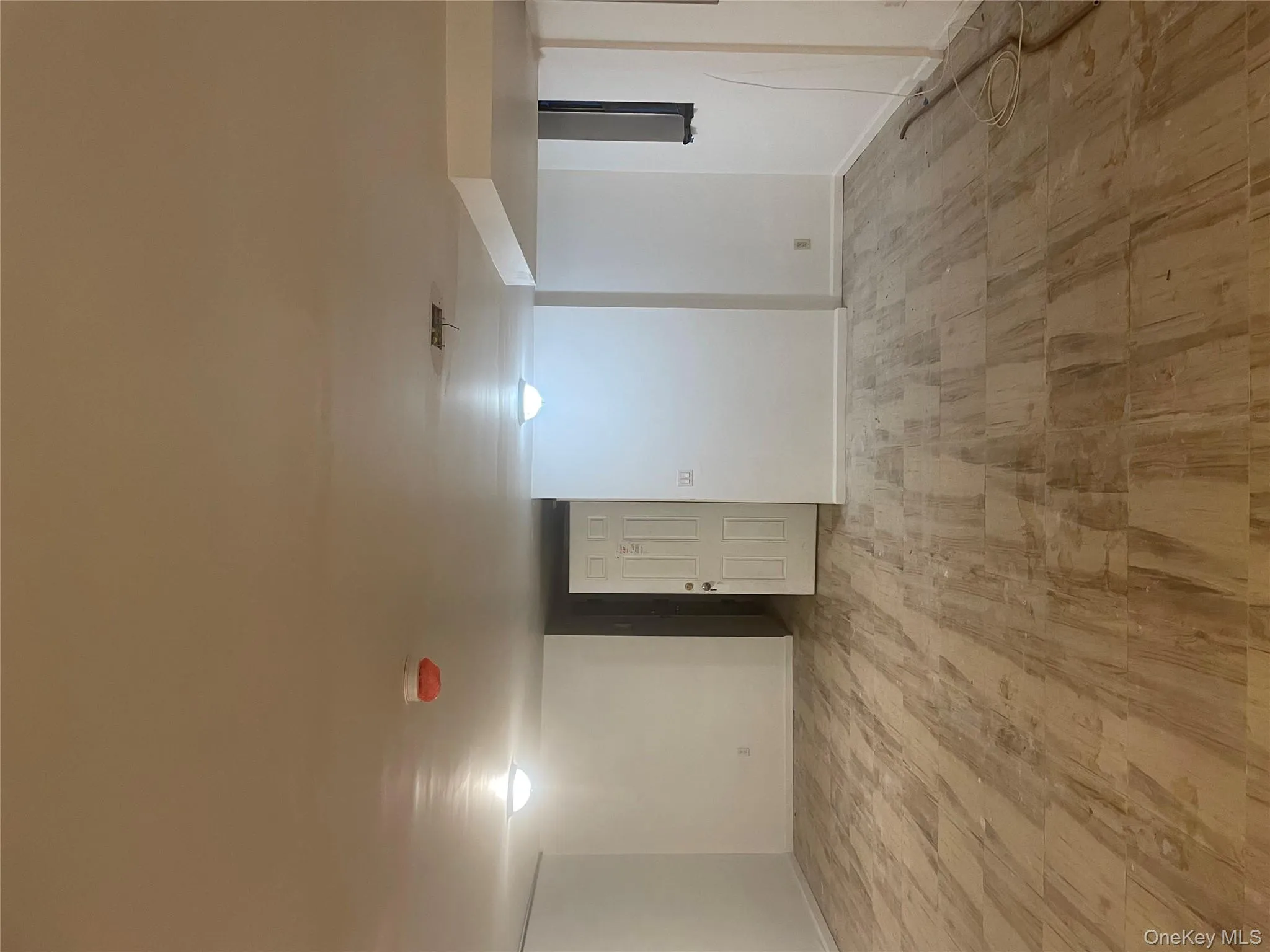 Finished basement featuring light wood finished floors and baseboards Finished basement featuring light wood finished floors and baseboards