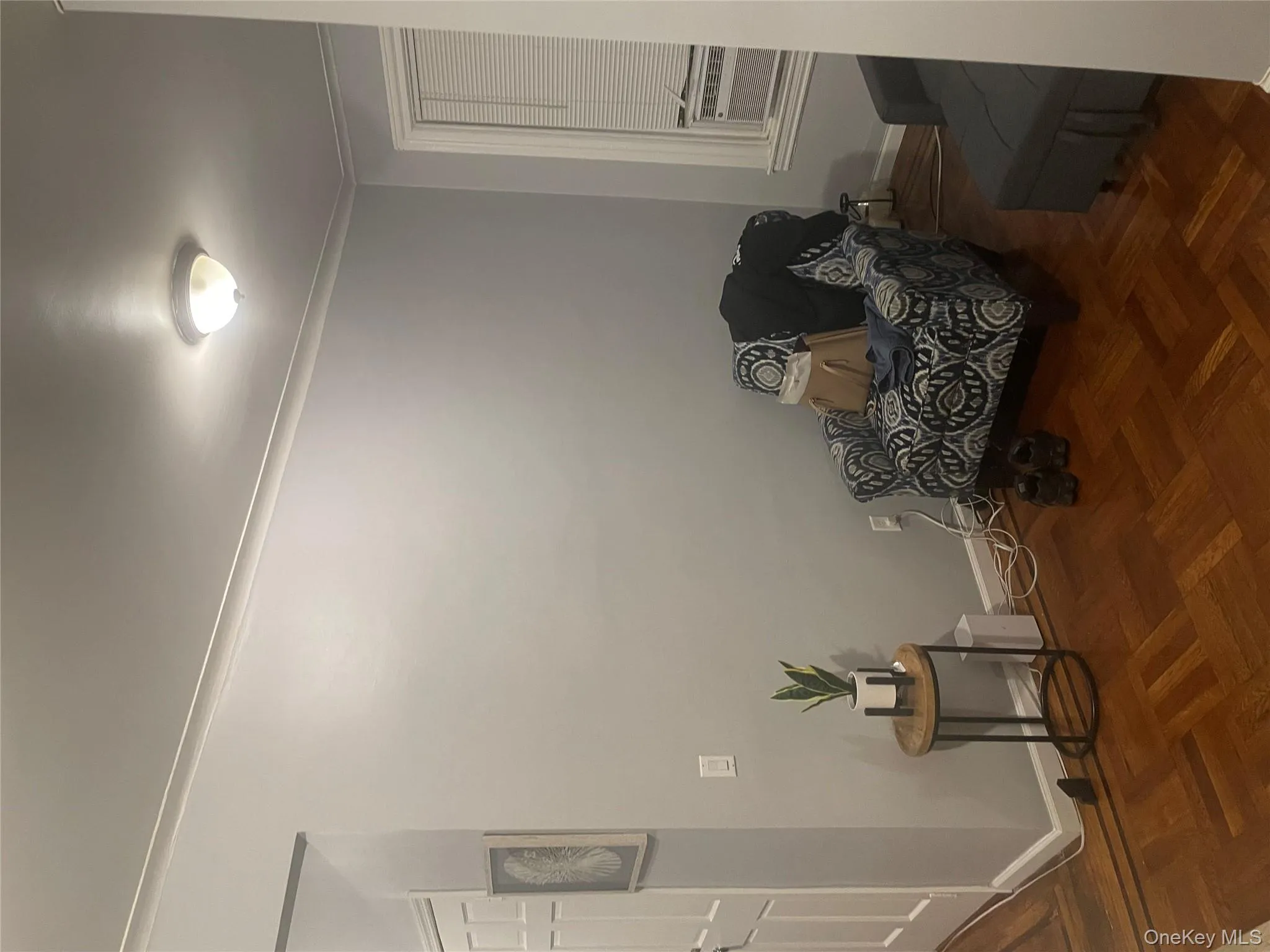 Living area featuring cooling unit, crown molding, and baseboards Living area featuring cooling unit, crown molding, and baseboards
