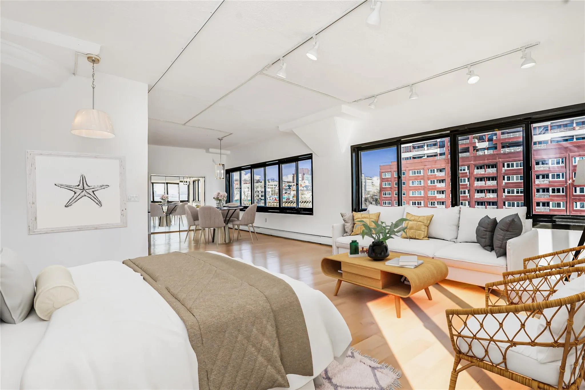 Bedroom featuring baseboard heating, wood finished floors, and track lighting Bedroom featuring baseboard heating, wood finished floors, and track lighting