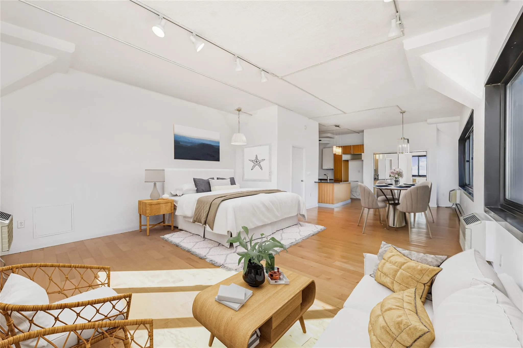 Bedroom with rail lighting and light wood-style flooring Bedroom with rail lighting and light wood-style flooring