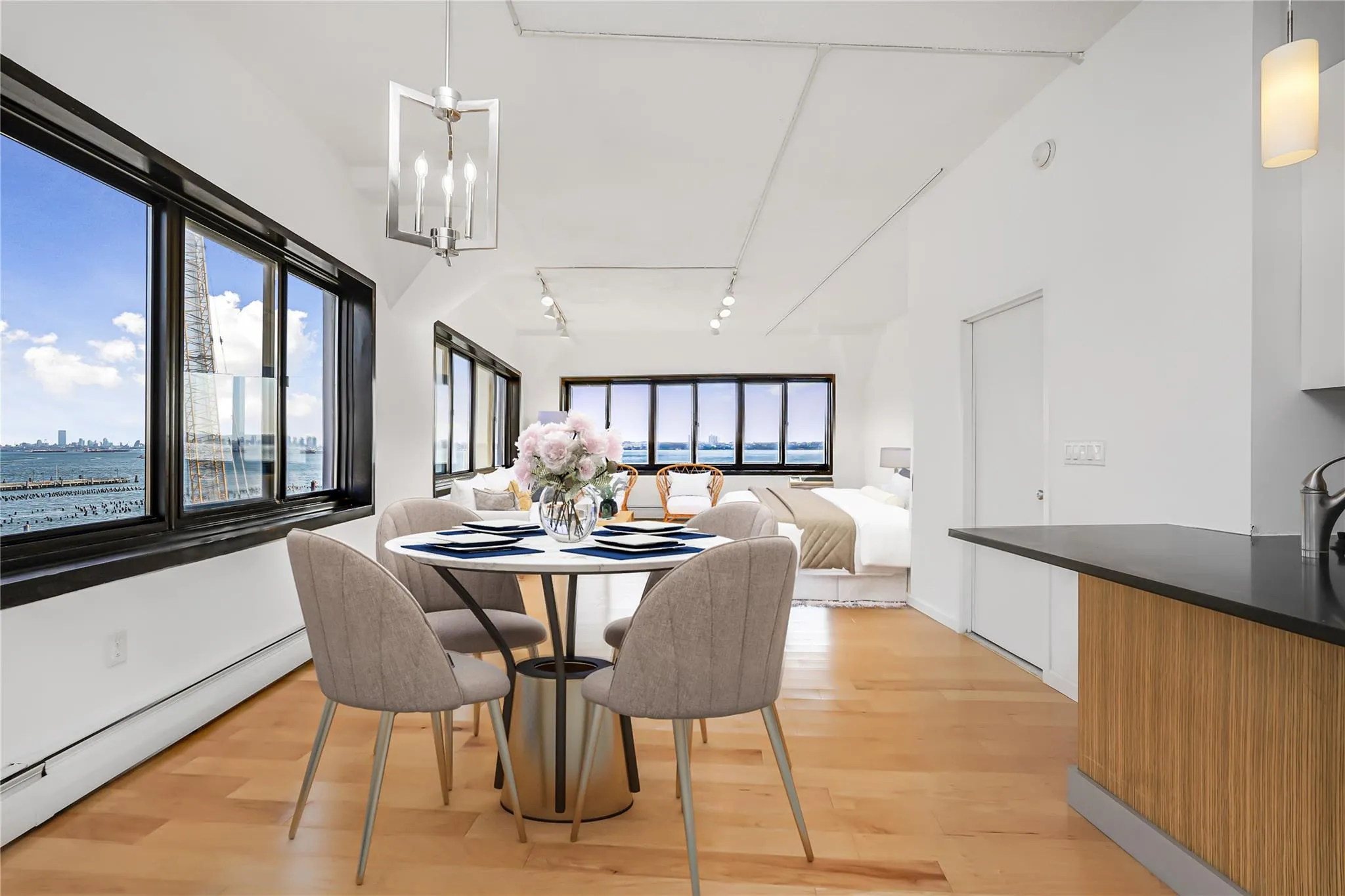 Dining area with a baseboard heating unit, track lighting, and light wood-style flooring Dining area with a baseboard heating unit, track lighting, and light wood-style flooring