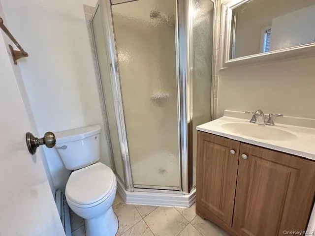 Bathroom featuring vanity and a shower stall Bathroom featuring vanity and a shower stall