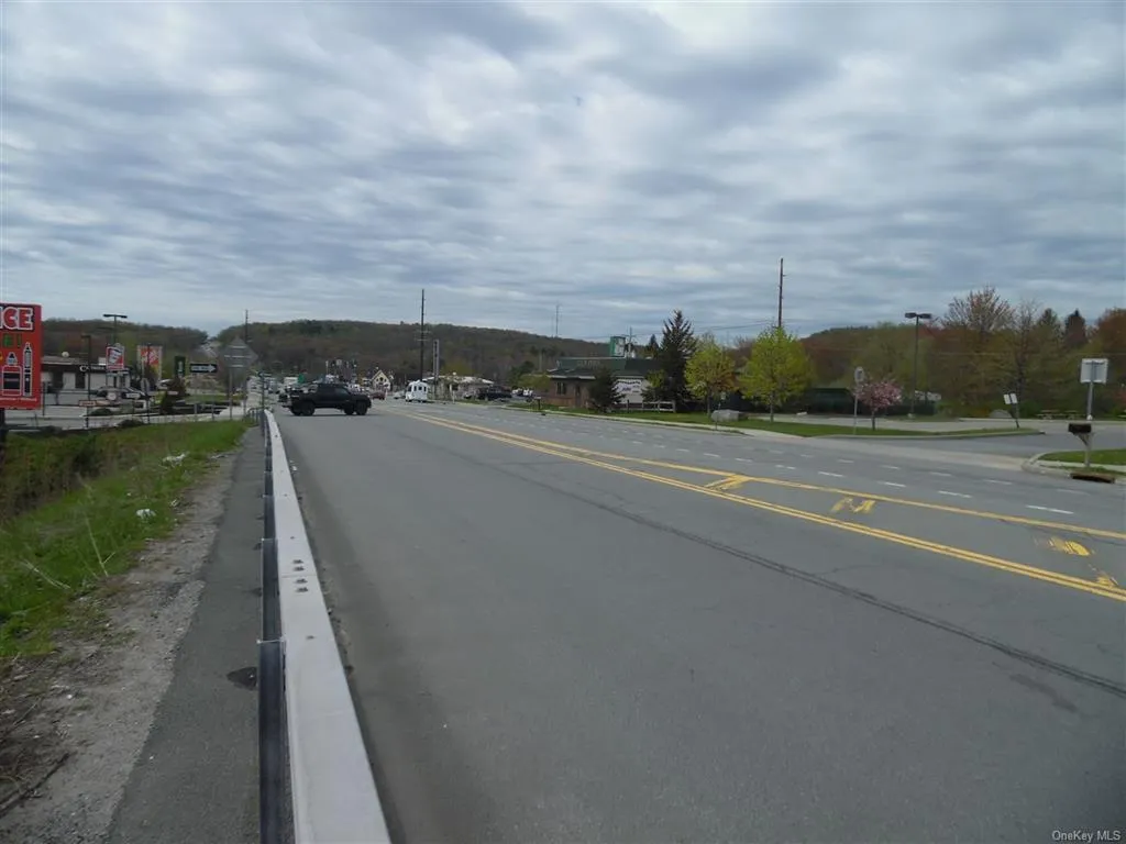View of asphalt road featuring curbs View of asphalt road featuring curbs