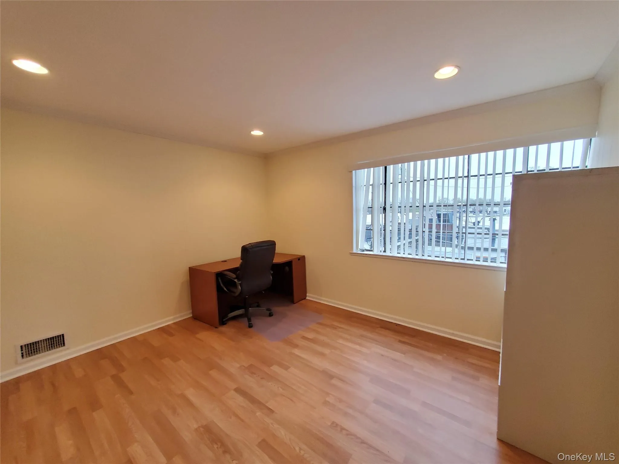 Private Office featuring wood finished floors, recessed lighting, and baseboards Private Office featuring wood finished floors, recessed lighting, and baseboards