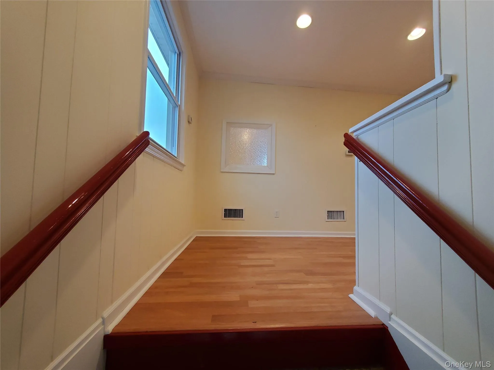 Stairs Landing with wood finished floors, baseboards, and recessed lighting Stairs Landing with wood finished floors, baseboards, and recessed lighting