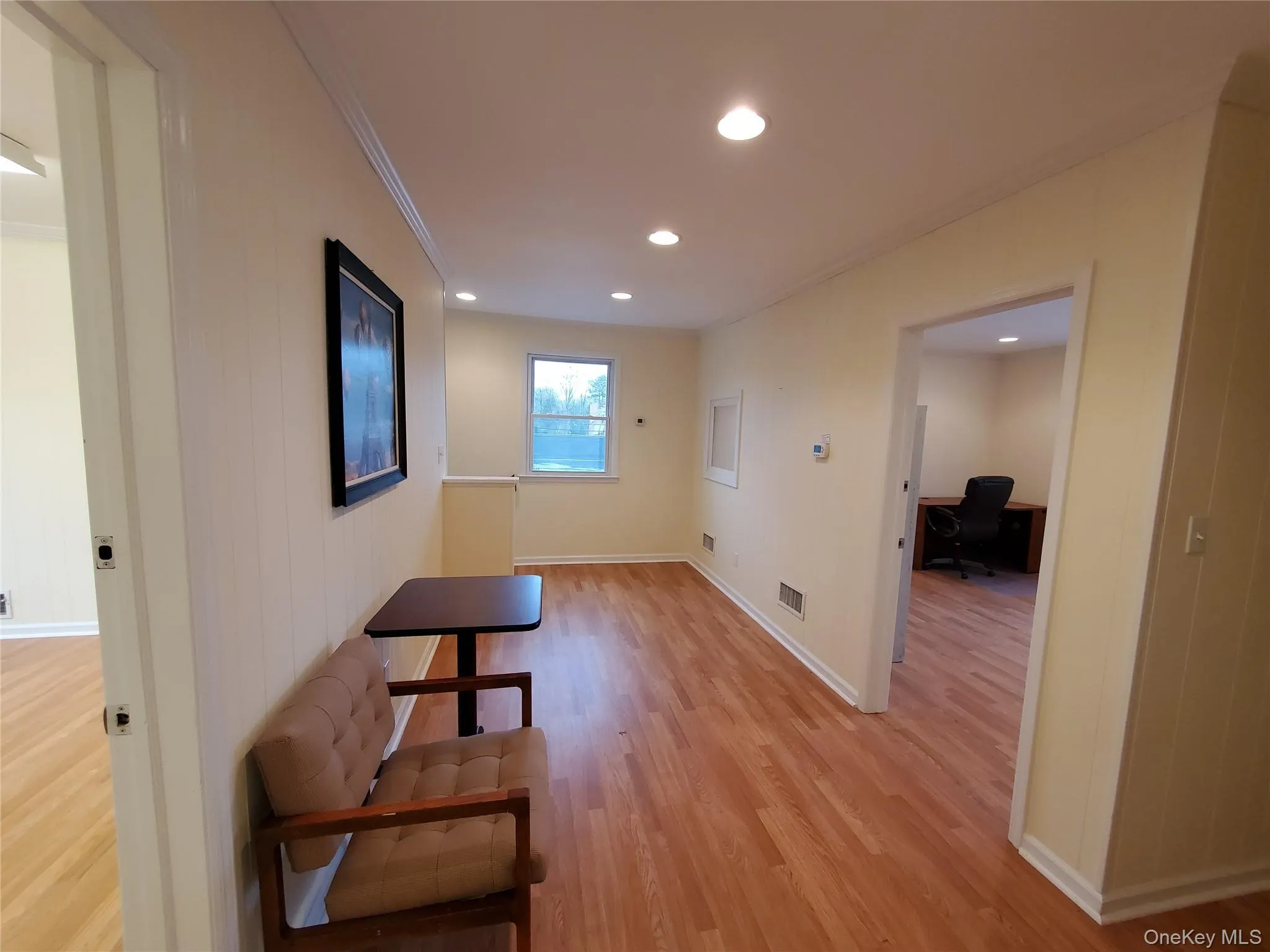 Corridor featuring ornamental molding, light wood-style flooring, an office area, recessed lighting, and baseboards Corridor featuring ornamental molding, light wood-style flooring, an office area, recessed lighting, and baseboards