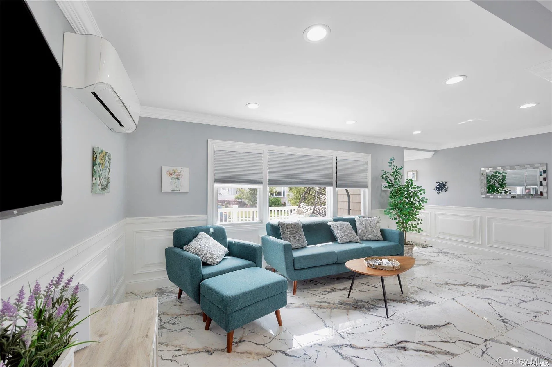 Living room with a wall unit AC, wainscoting, recessed lighting, ornamental molding, and marble tiled floors Living room with a wall unit AC, wainscoting, recessed lighting, ornamental molding, and marble tiled floors