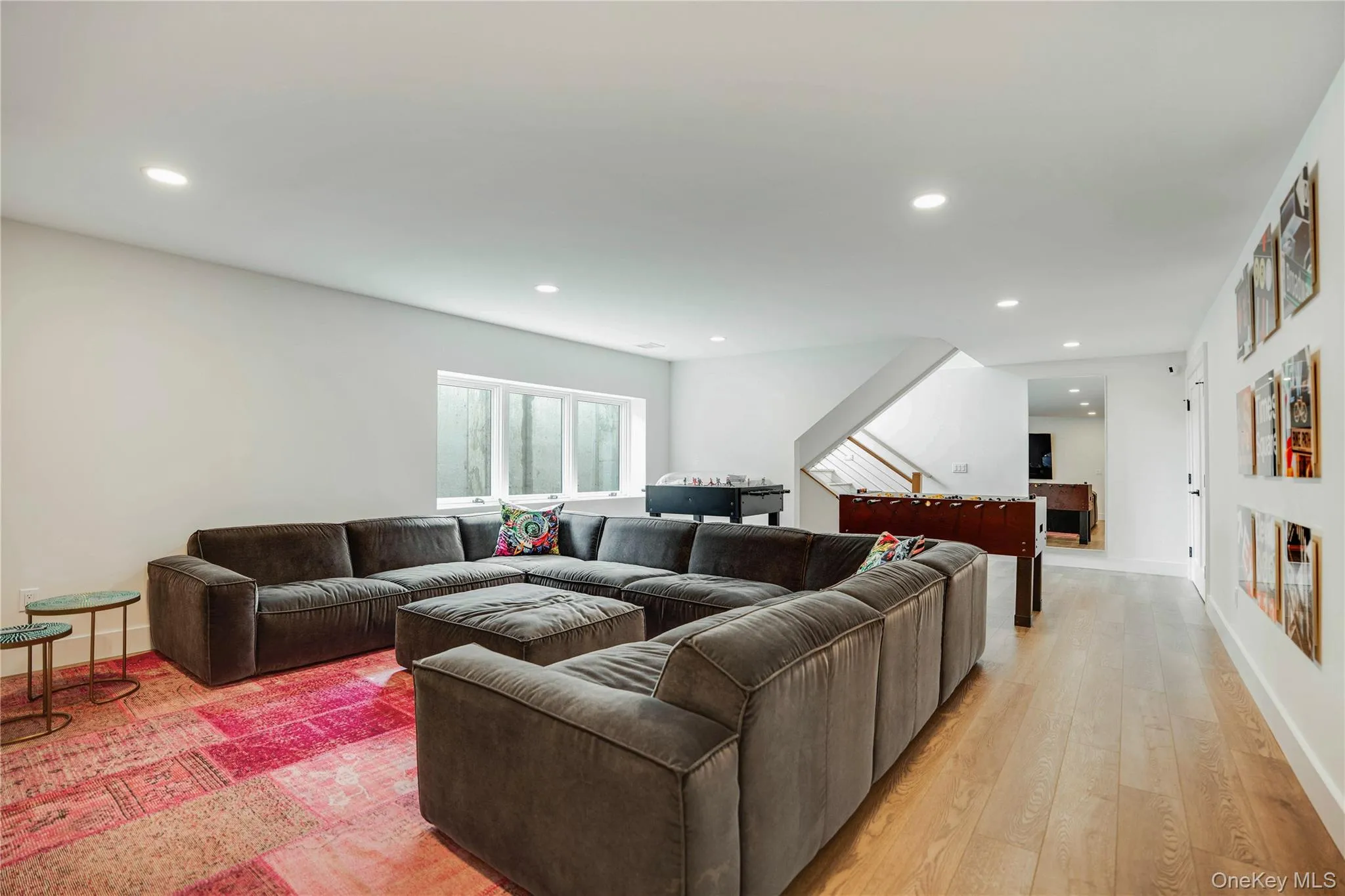 Living room with light wood-style flooring, recessed lighting, and baseboards Living room with light wood-style flooring, recessed lighting, and baseboards