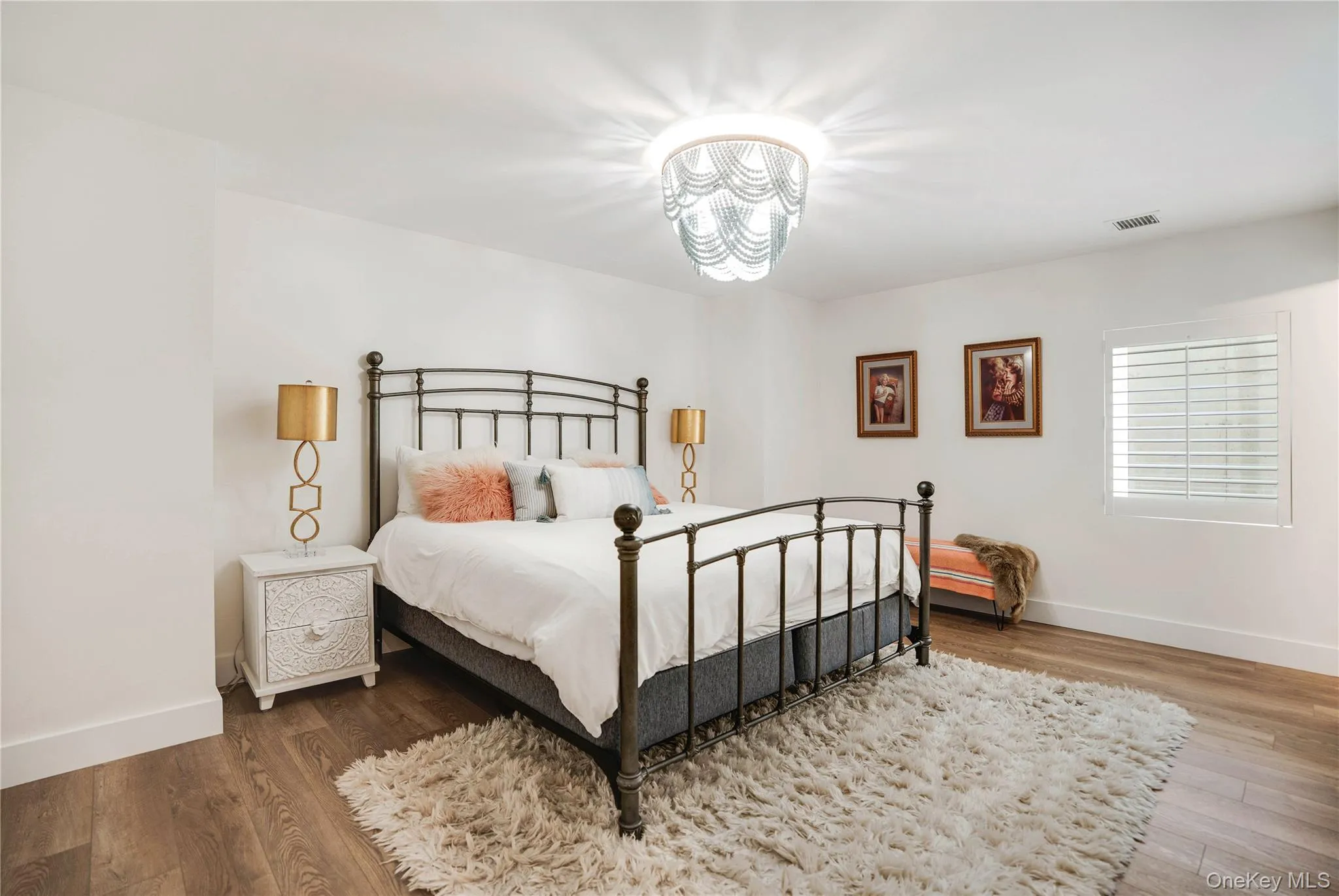 Bedroom featuring a chandelier, baseboards, and wood finished floors Bedroom featuring a chandelier, baseboards, and wood finished floors