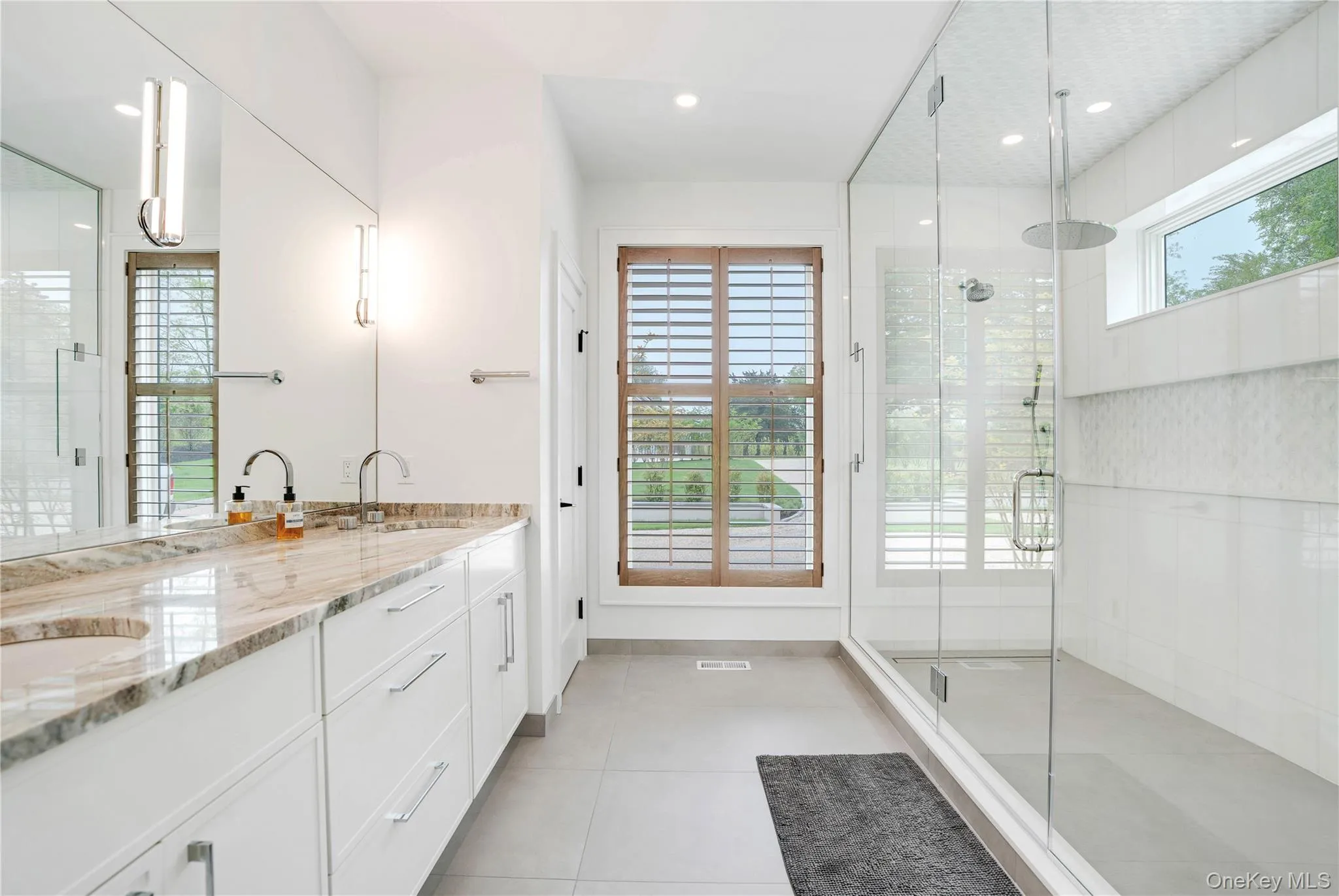 Full bathroom with a large shower stall, double vanity, tile patterned flooring, and recessed lighting Full bathroom with a large shower stall, double vanity, tile patterned flooring, and recessed lighting