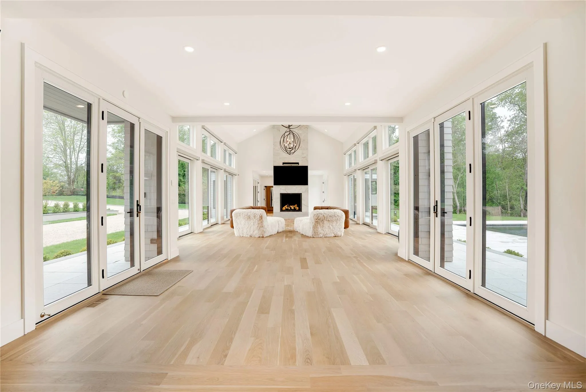 Living Room featuring french doors and sliders and vaulted ceiling Living Room featuring french doors and sliders and vaulted ceiling