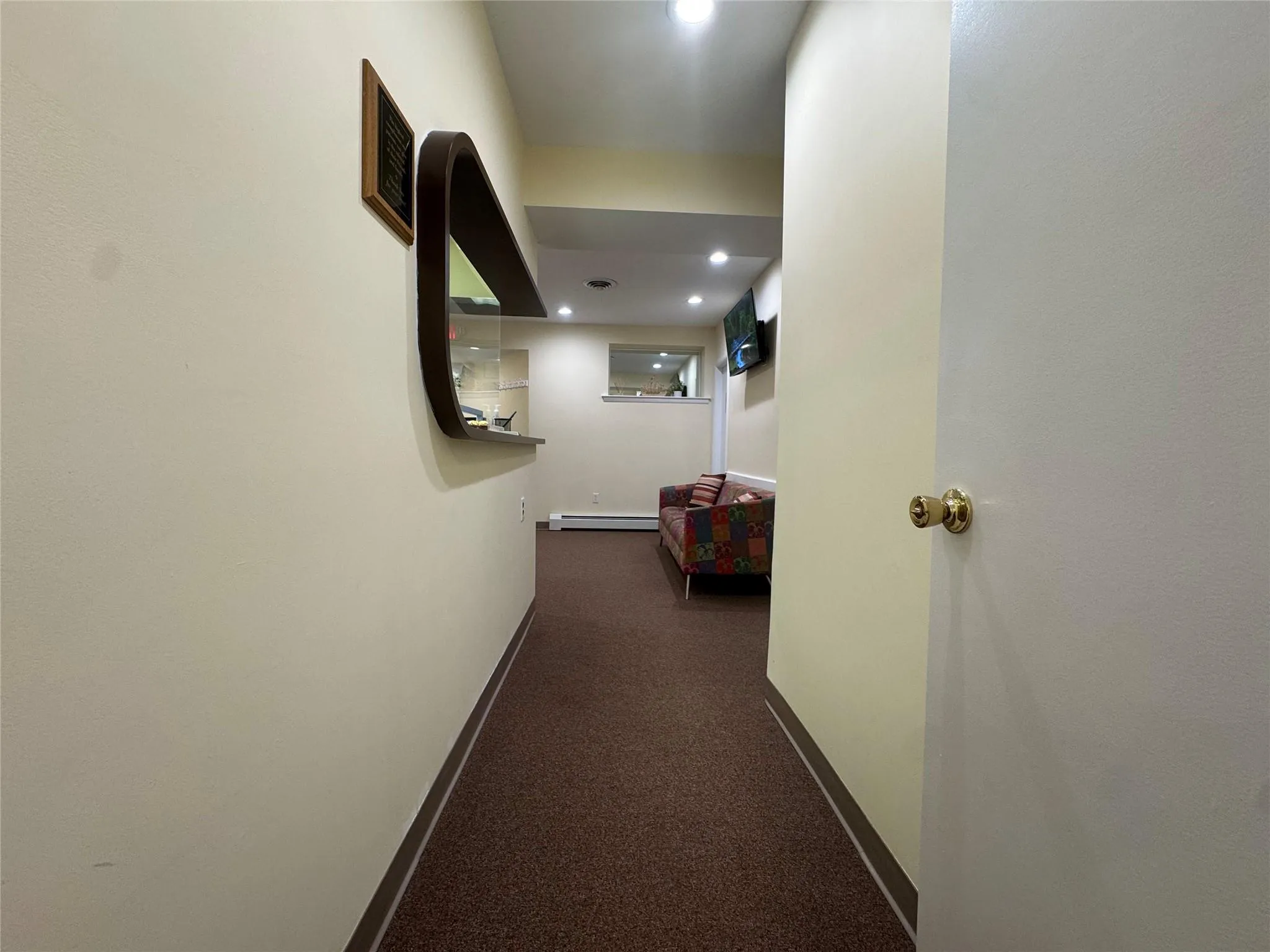 Hallway featuring baseboards, dark carpet, a baseboard radiator, and recessed lighting Hallway featuring baseboards, dark carpet, a baseboard radiator, and recessed lighting