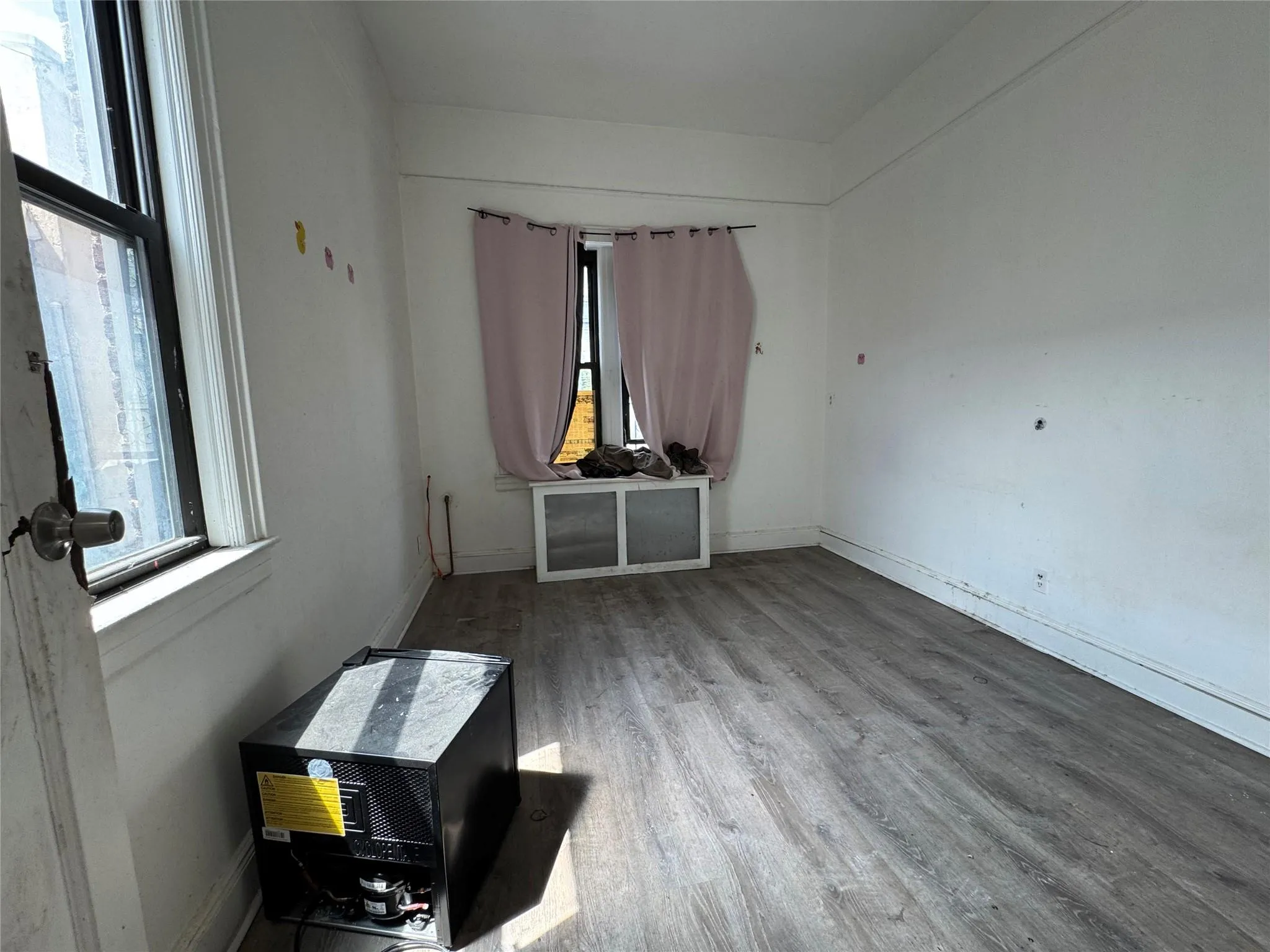 Empty room featuring wood finished floors and baseboards Empty room featuring wood finished floors and baseboards