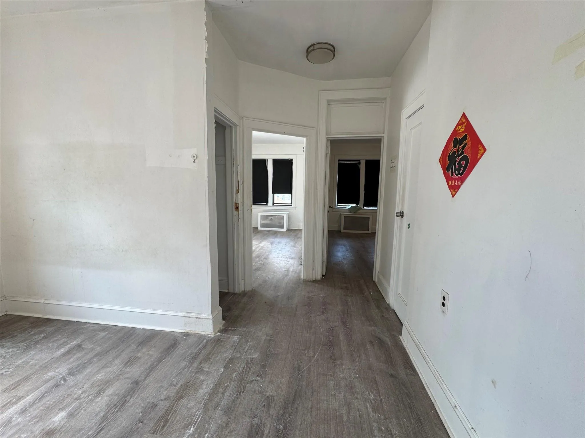Corridor featuring wood finished floors and baseboards Corridor featuring wood finished floors and baseboards