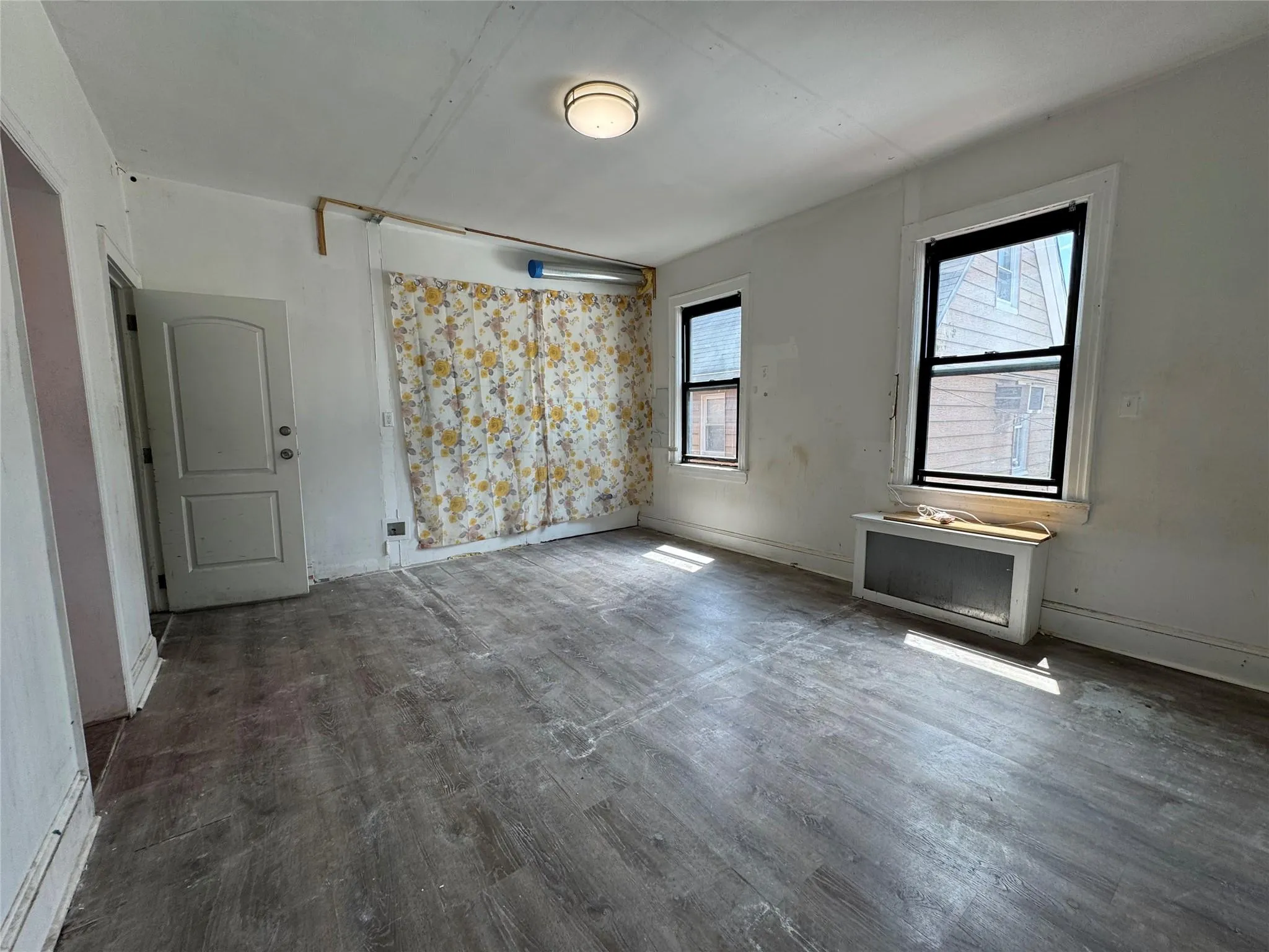 Empty room featuring wood finished floors and baseboards Empty room featuring wood finished floors and baseboards