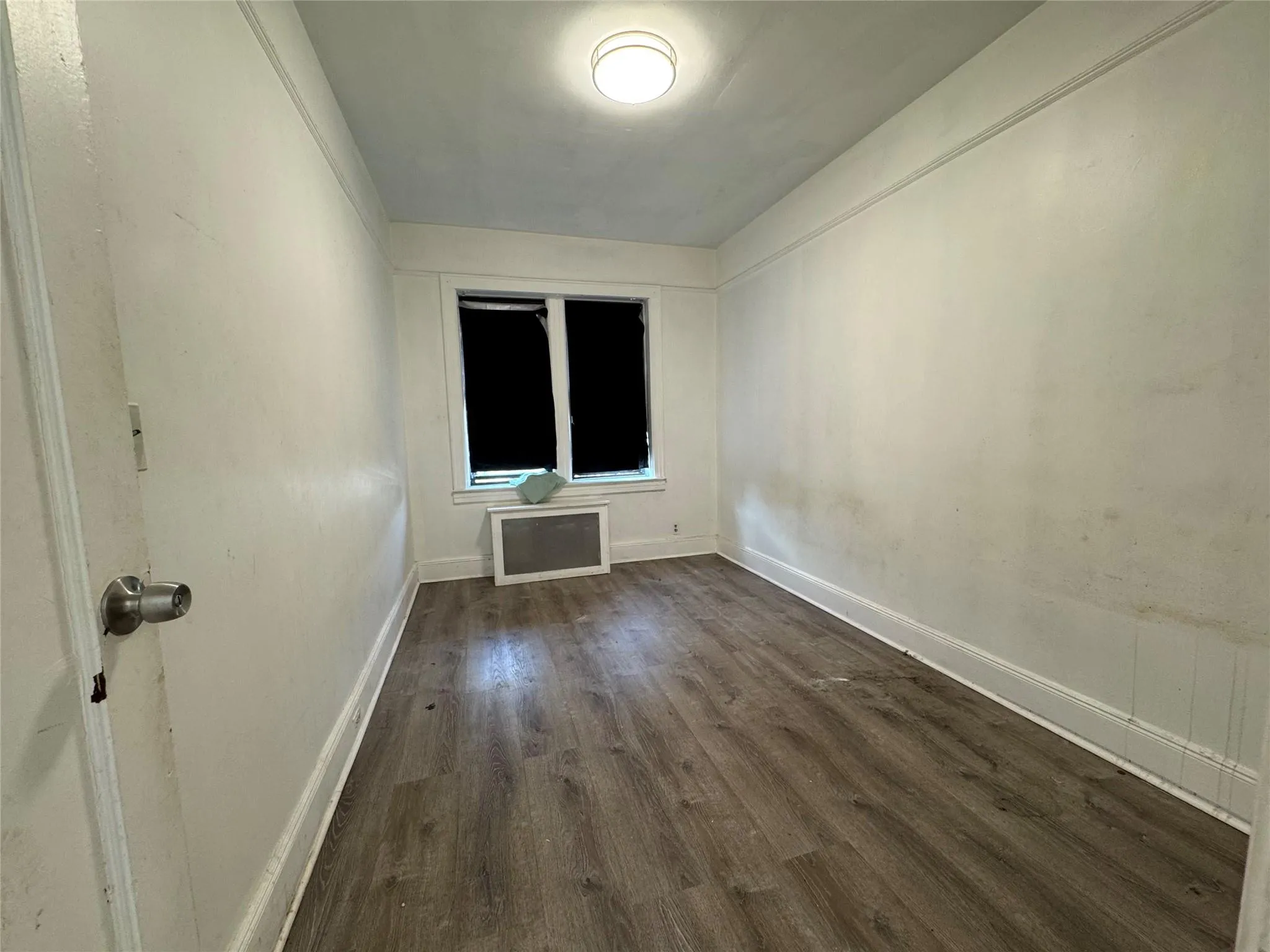 Empty room featuring dark wood finished floors Empty room featuring dark wood finished floors