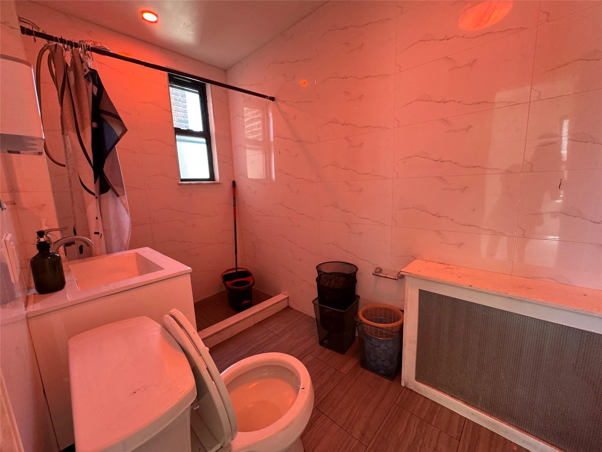 Full bath featuring a shower with curtain, toilet, and a sink Full bath featuring a shower with curtain, toilet, and a sink