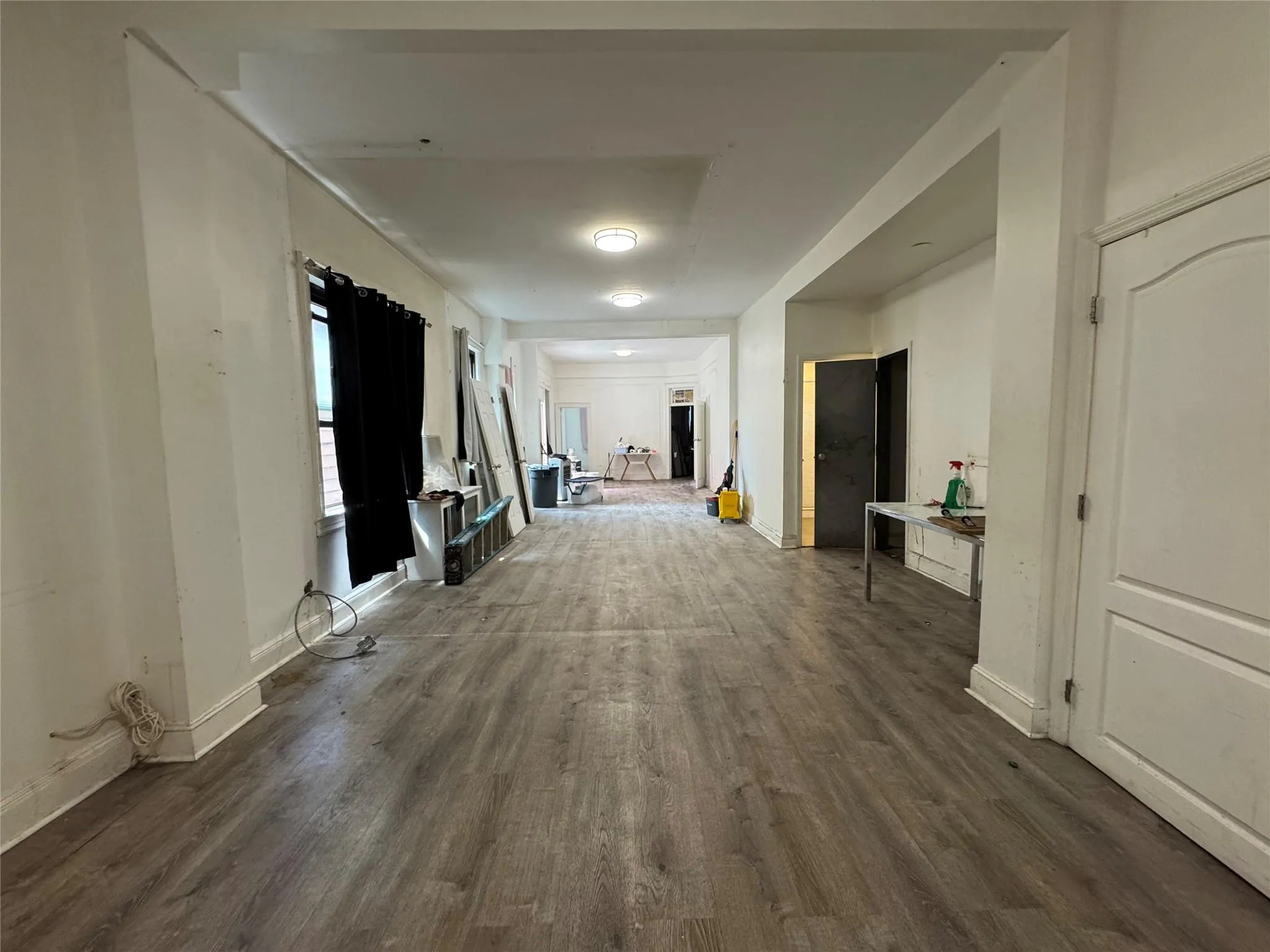 Hallway with wood finished floors and baseboards Hallway with wood finished floors and baseboards
