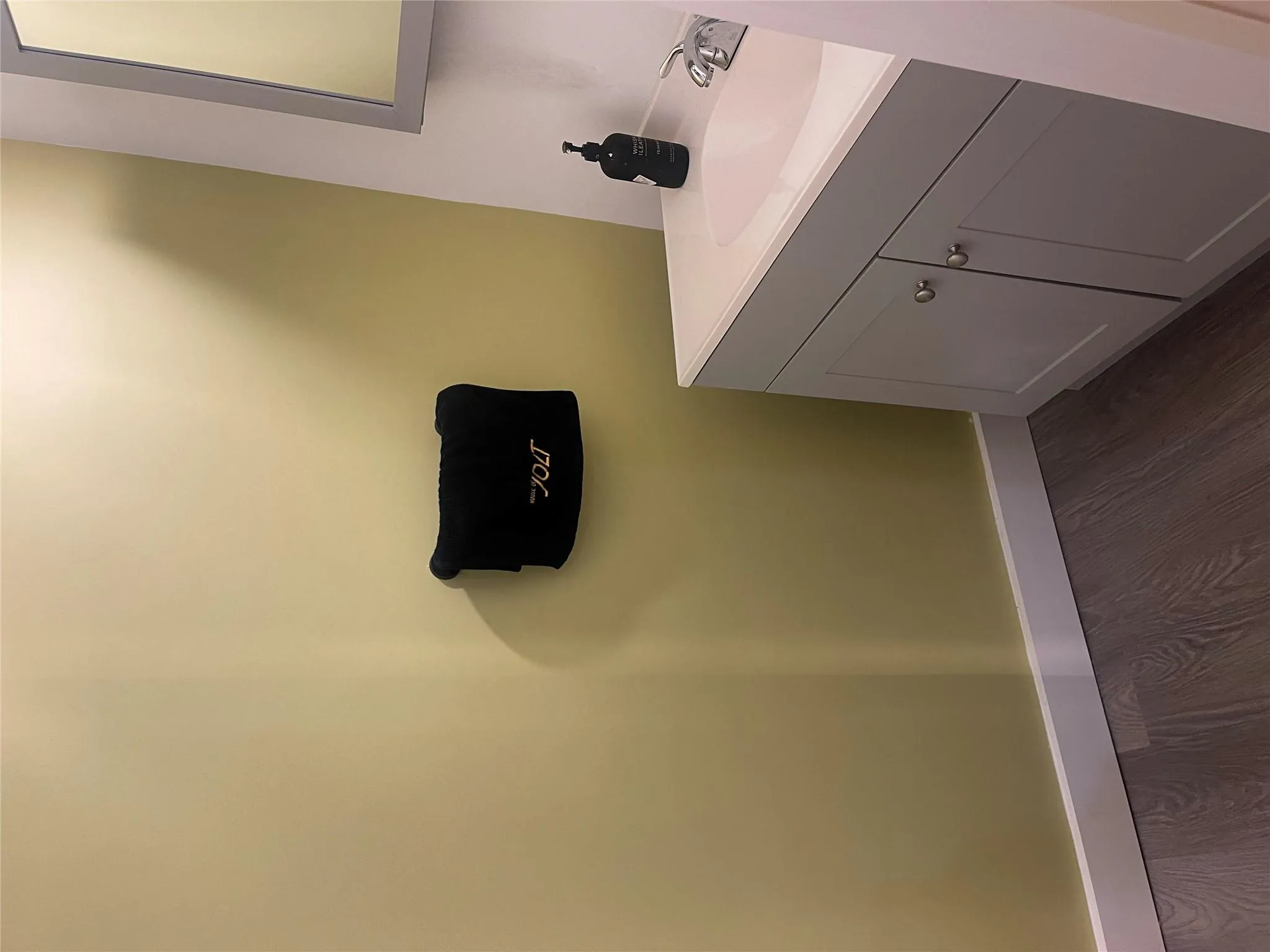 Bathroom with vanity, wood finished floors, and baseboards Bathroom with vanity, wood finished floors, and baseboards