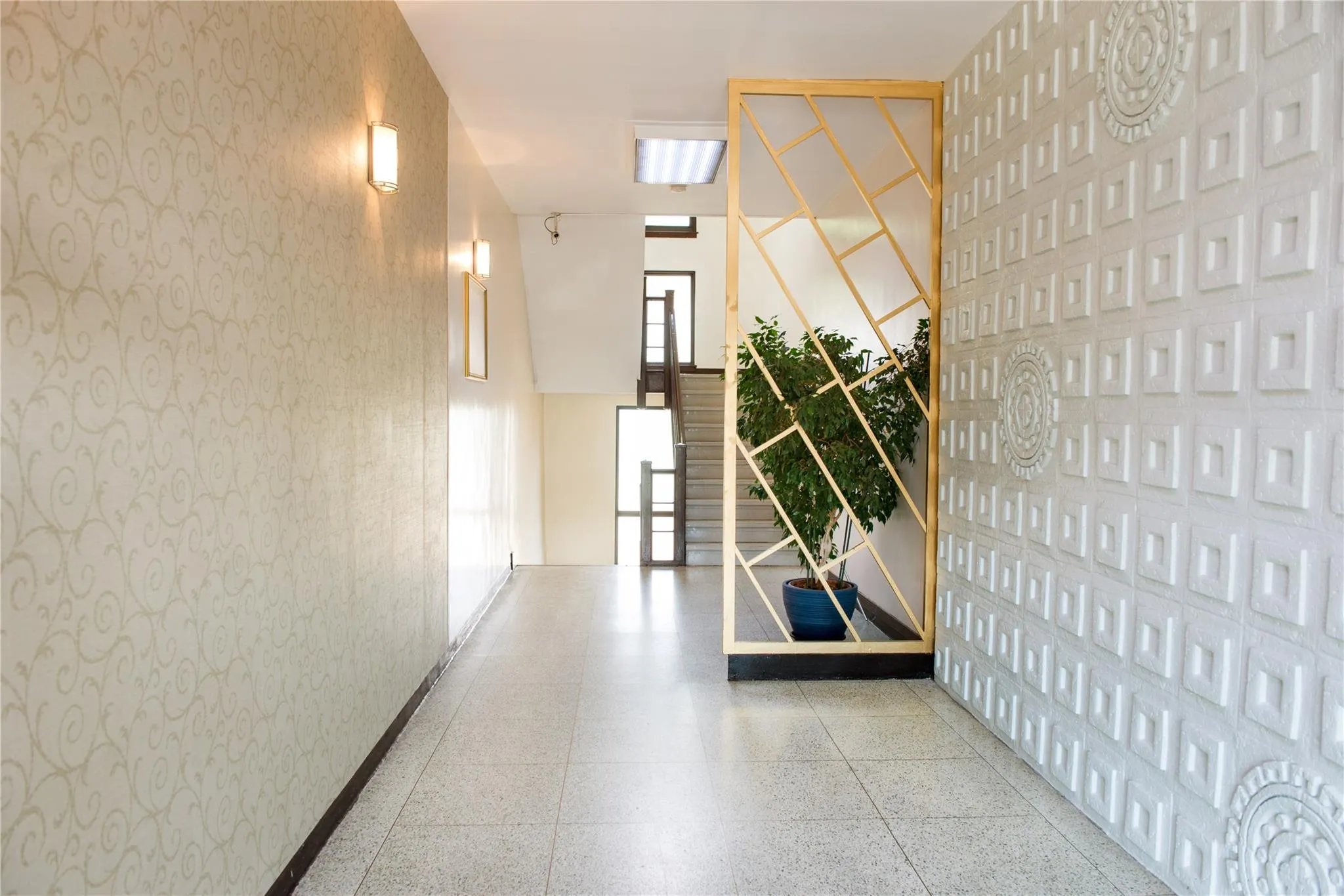 Hallway with stairway and wallpapered walls Hallway with stairway and wallpapered walls