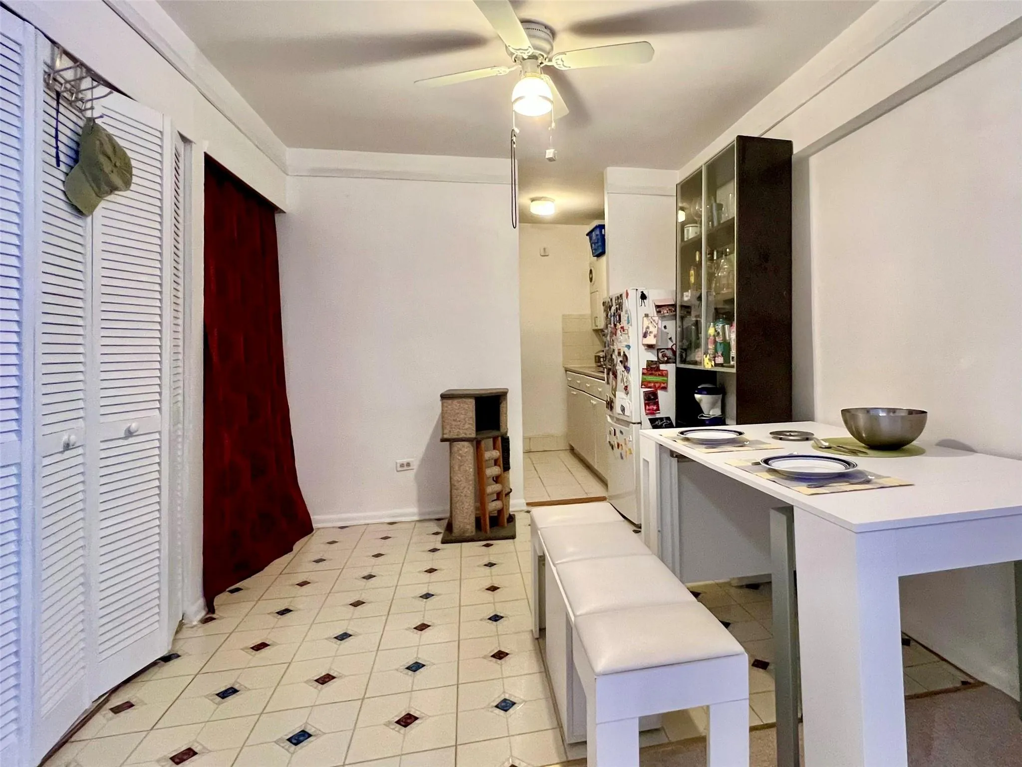 Kitchen with ceiling fan, glass insert cabinets, light countertops, and a peninsula Kitchen with ceiling fan, glass insert cabinets, light countertops, and a peninsula