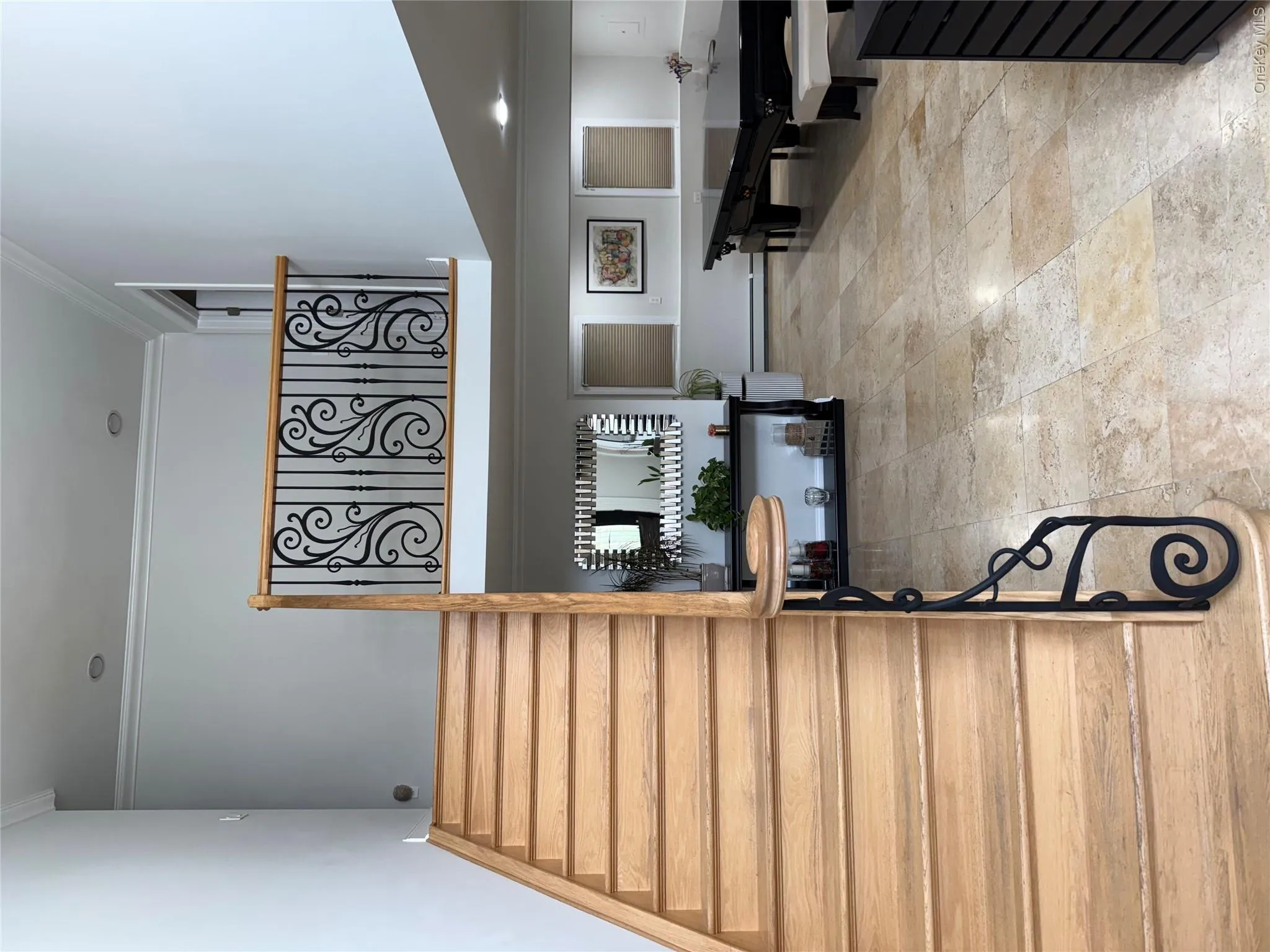 Stairway featuring crown molding, baseboard heating, billiards table, and a high ceiling Stairway featuring crown molding, baseboard heating, billiards table, and a high ceiling