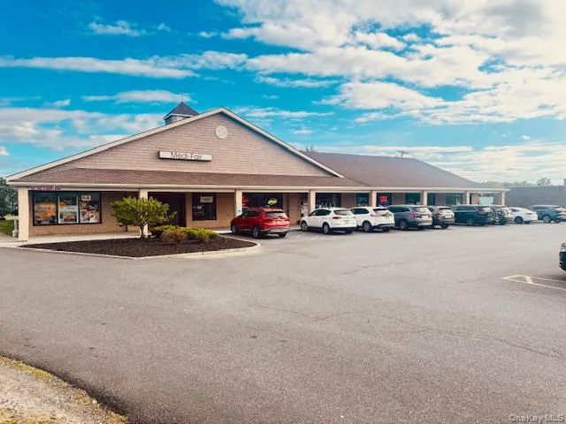 View of property with uncovered parking View of property with uncovered parking