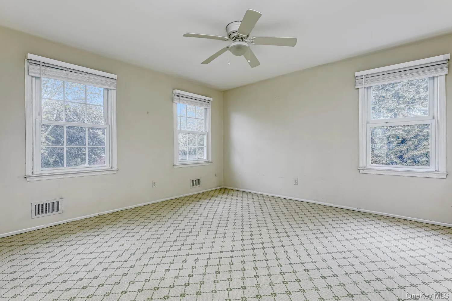 Carpeted spare room featuring baseboards and ceiling fan Carpeted spare room featuring baseboards and ceiling fan