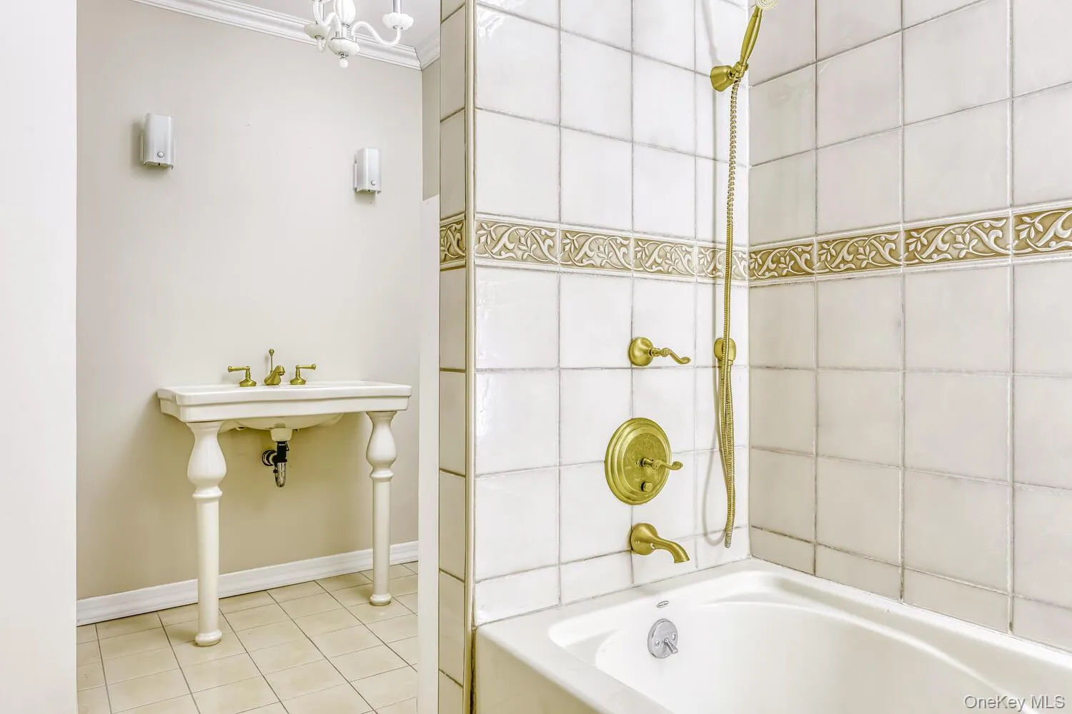 Full bathroom with tile patterned floors, crown molding, bathing tub / shower combination, and baseboards Full bathroom with tile patterned floors, crown molding, bathing tub / shower combination, and baseboards