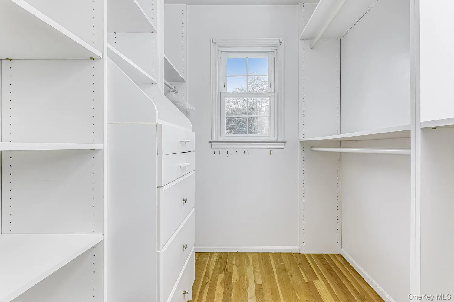 Walk in closet with wood finished floors Walk in closet with wood finished floors