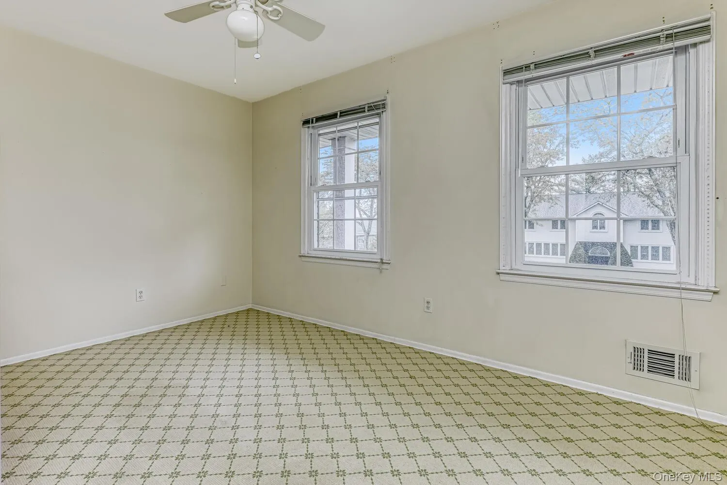 Spare room with light carpet, a ceiling fan, and baseboards Spare room with light carpet, a ceiling fan, and baseboards