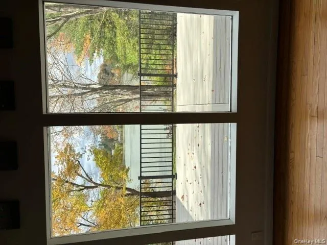 Doorway with a water view and wood-type flooring Doorway with a water view and wood-type flooring