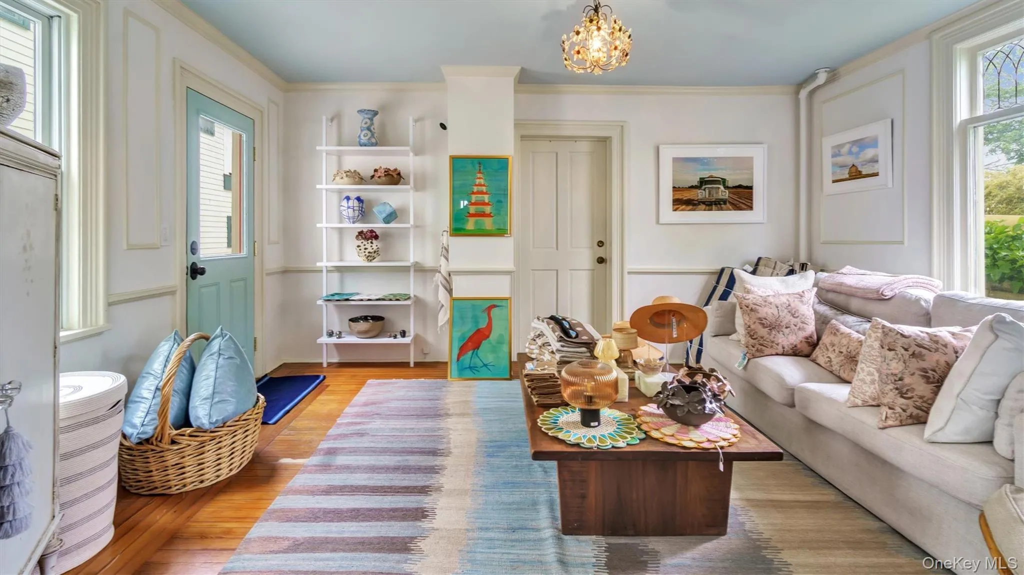 Living area featuring light wood-type flooring, and crown molding Living area featuring light wood-type flooring, and crown molding
