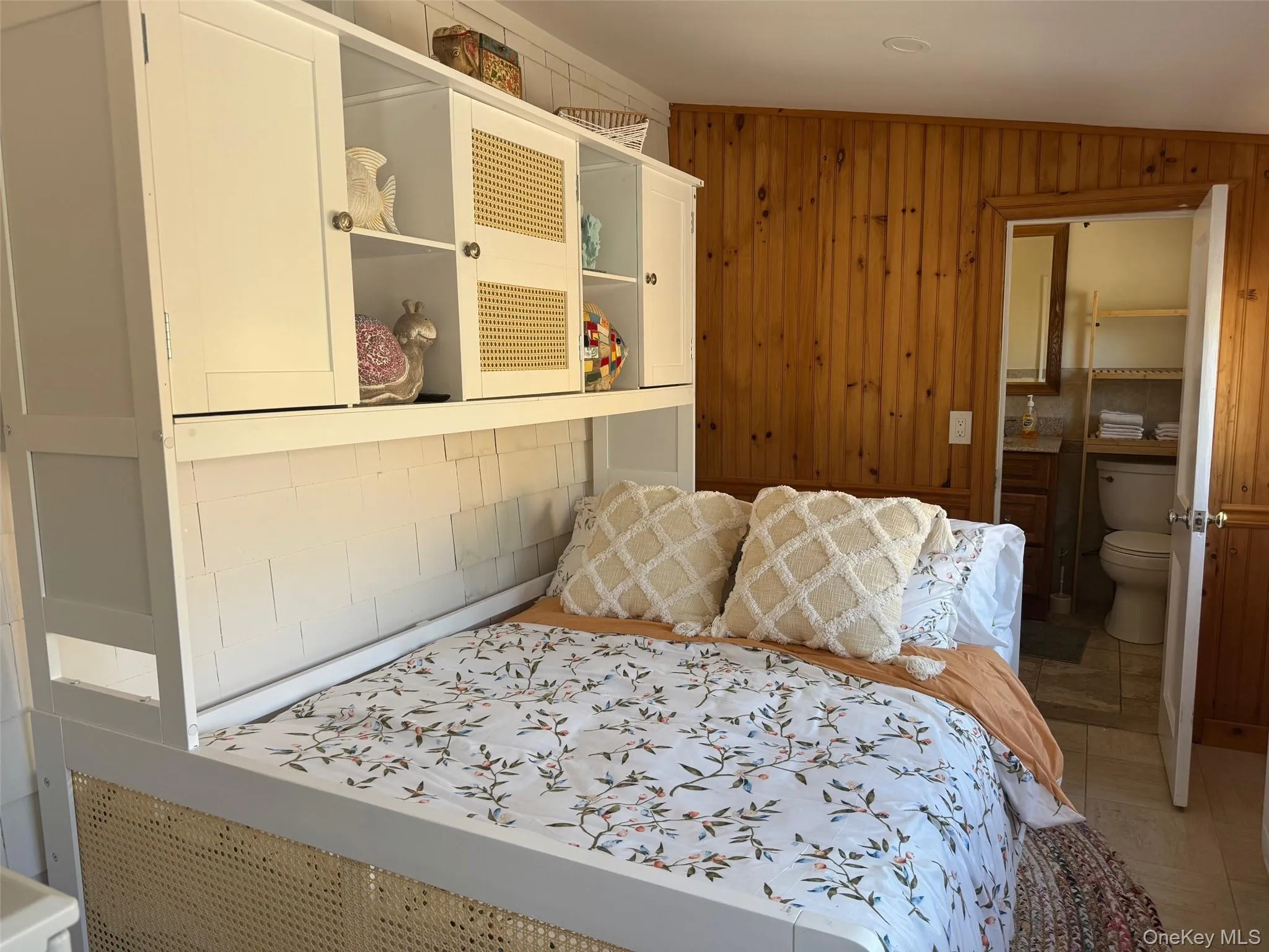Bedroom featuring wooden walls Bedroom featuring wooden walls