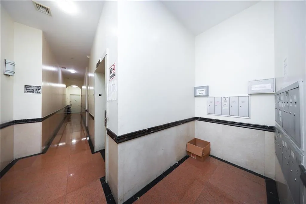 Corridor featuring mail area and arched walkways Corridor featuring mail area and arched walkways
