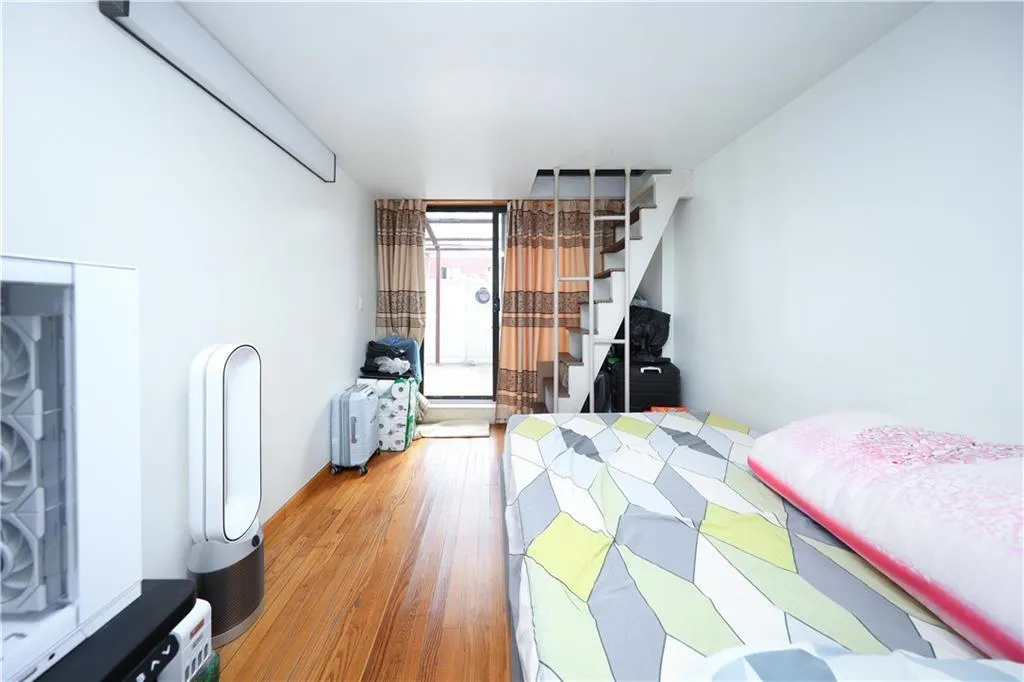 Bedroom featuring light wood-type flooring and access to exterior Bedroom featuring light wood-type flooring and access to exterior