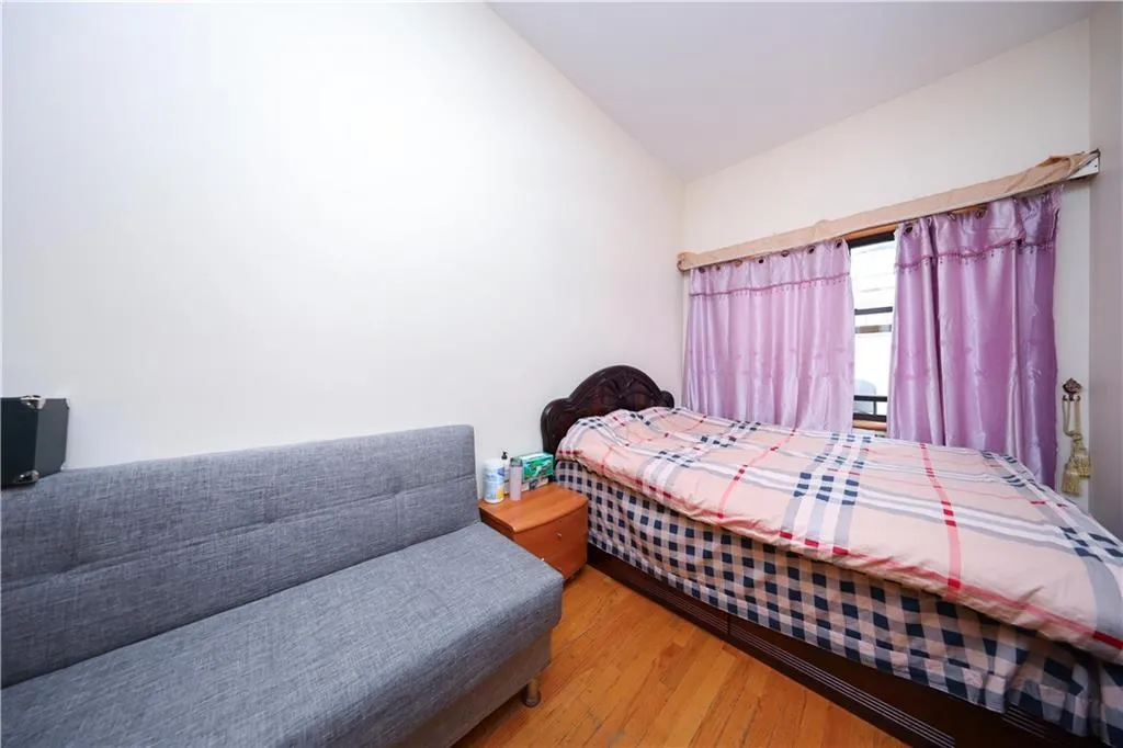 Bedroom with wood finished floors and lofted ceiling Bedroom with wood finished floors and lofted ceiling